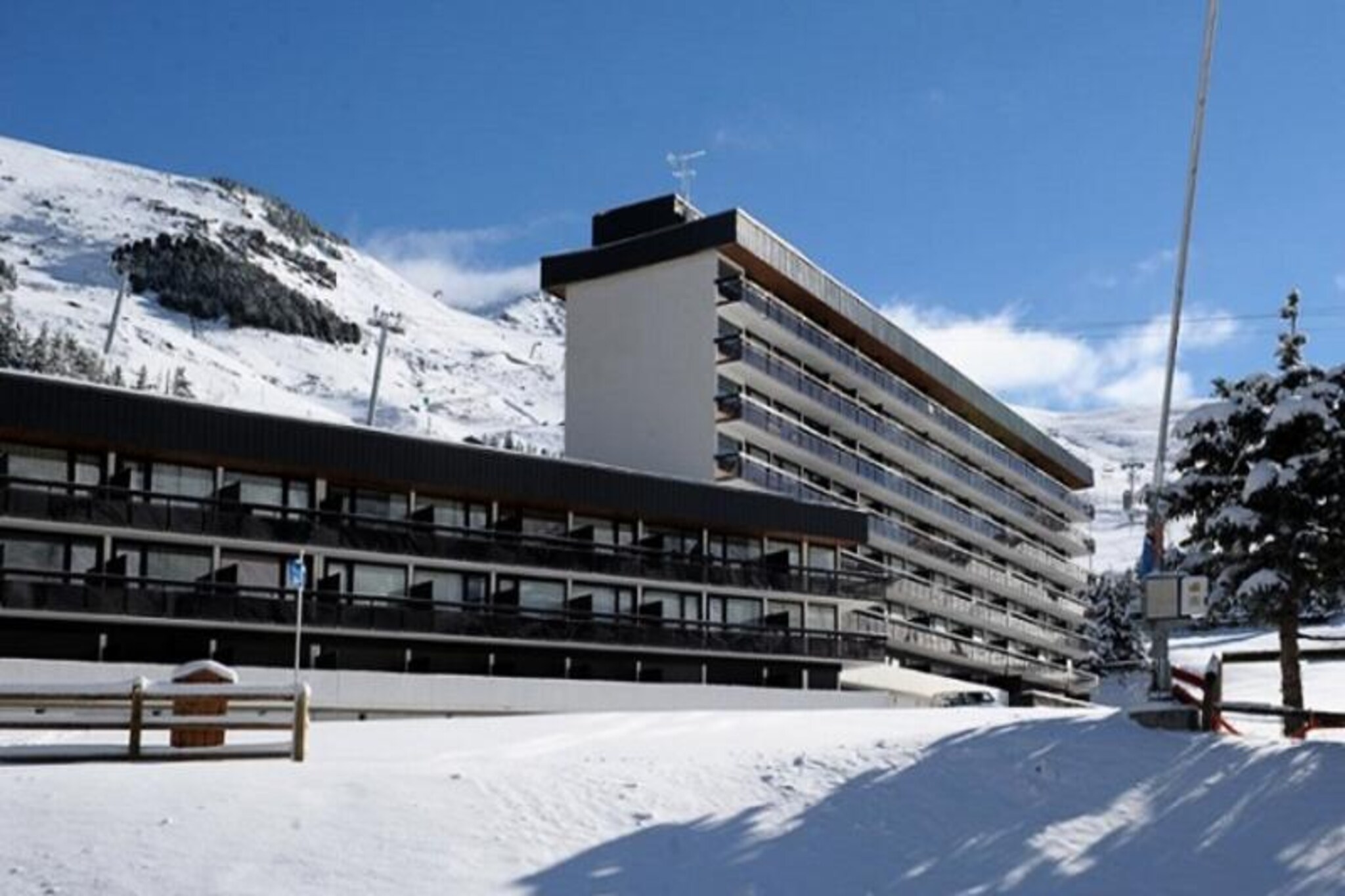 In the vibrant La Croisette district of the resort, this charming apartment invites you to experience the perfect alpine getaway. With ski lifts located right at the foot of the building, you’ll enjoy seamless ski-in/ski-out access to the slopes, including beginner-friendly pistes just steps away. The bustling shopping arcade is only a two-minute walk, while the bus station is conveniently located five minutes away, ensuring effortless connectivity throughout your stay. The Pioupiou children's club, offering daycare and a snow garden, is just a ten-minute stroll across La Croisette, making this location ideal for families with young adventurers. \n\nThis cozy apartment spans 42m² and comfortably accommodates up to six guests. Situated on the 1st floor, it features a south-facing balcony that bathes the space in natural light and offers delightful views of the surrounding alpine scenery. The living room is equipped with a sofa bed, TV, and DVD player, creating a welcoming space to unwind after a day on the slopes. The bedroom includes two sets of bunk beds and an additional TV, ensuring comfort and entertainment for all. The apartment also boasts parquet flooring throughout, adding warmth and charm to the interiors. \n\nThe kitchen is fully equipped with modern appliances, including a refrigerator, conventional oven, microwave, dishwasher, and specialty items like raclette and sandwich grills. A separate bathroom with a bathtub and a washing machine, along with a separate toilet, provide added convenience. Please note that bunk beds are unsuitable for children under six years old, and pets are not permitted. \n\nWith its unbeatable location, family-friendly amenities, and cozy alpine charm, this apartment is a perfect choice for those seeking a memorable mountain retreat. Whether you're here to ski, shop, or simply relax, the heart of La Croisette is ready to welcome you.