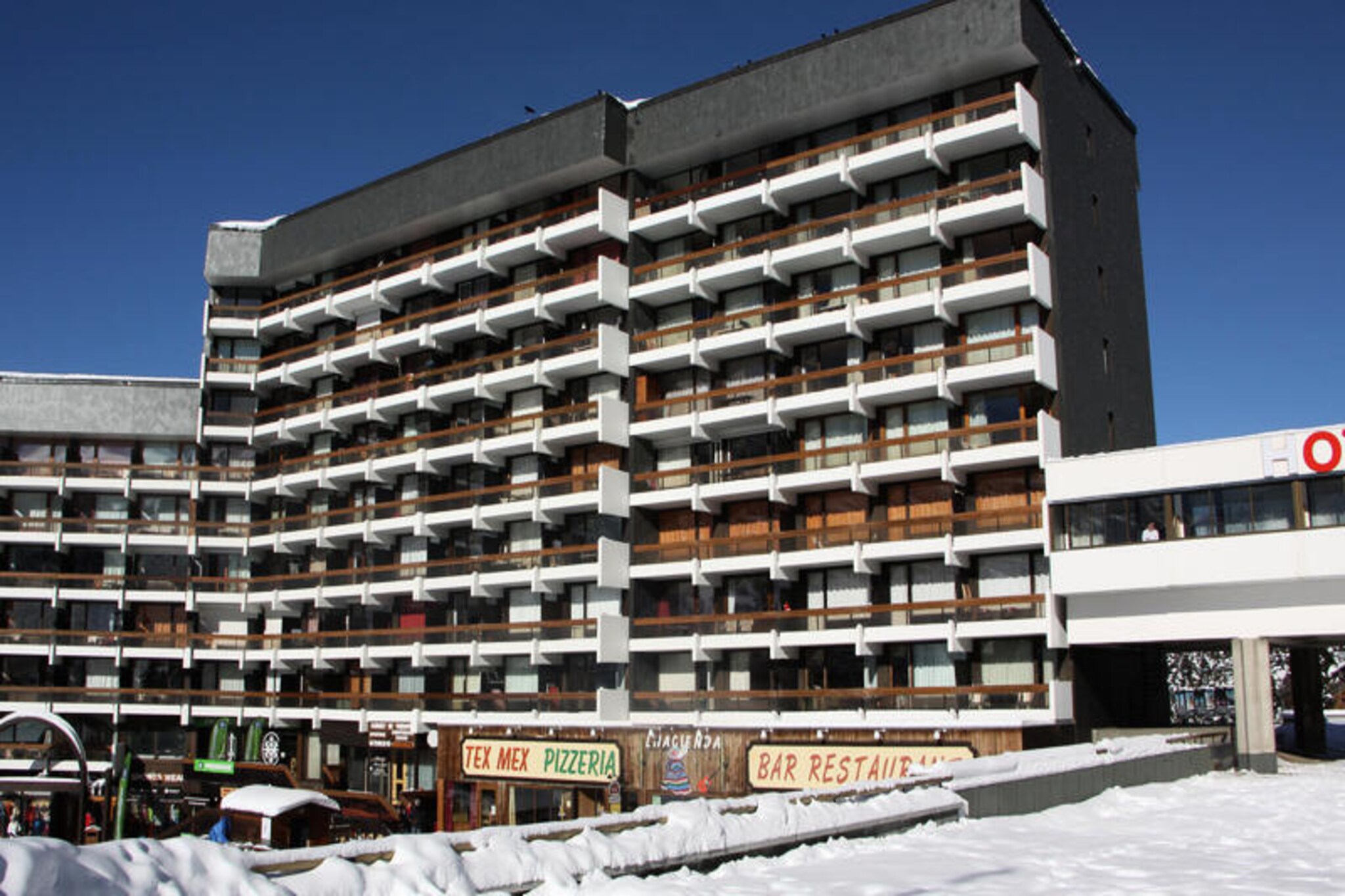 High above the bustling La Croisette district, this cozy studio apartment offers a serene retreat for those seeking the perfect alpine getaway. Imagine waking up to the crisp mountain air and stepping onto your private north-facing balcony to admire the tranquil surroundings. Whether you're here for skiing adventures or a peaceful escape, this charming residence blends convenience with comfort in the heart of the French Alps. \n\nRecently renovated, the 17 m² studio is thoughtfully designed to accommodate up to three guests. The living area features two single beds and a pull-out bed, ensuring restful nights after days filled with exploration. A compact yet well-equipped kitchen boasts a two-burner cooktop, combination oven, refrigerator, mini dishwasher, toaster, kettle, and coffee maker, making it easy to prepare meals. The bathroom includes a bathtub and toilet, offering a relaxing space to unwind. With double-glazed windows and heating, you'll stay cozy no matter the season.\n\nThe Chavière residence provides direct access to the slopes, making it ideal for winter sports enthusiasts. The building connects to a shopping arcade, ensuring all essentials are within reach, while a daycare center is conveniently located just 300 meters away. Free outdoor parking at the foot of the building adds to the ease of your stay, and paid Wi-Fi access is available for those who need to stay connected.\n\nWhether you're drawn to the thrill of the slopes or the charm of the alpine lifestyle, this studio is your gateway to an unforgettable mountain experience. With its prime location and thoughtful amenities, it’s the perfect choice for couples or small families looking to immerse themselves in the beauty of the French Alps.