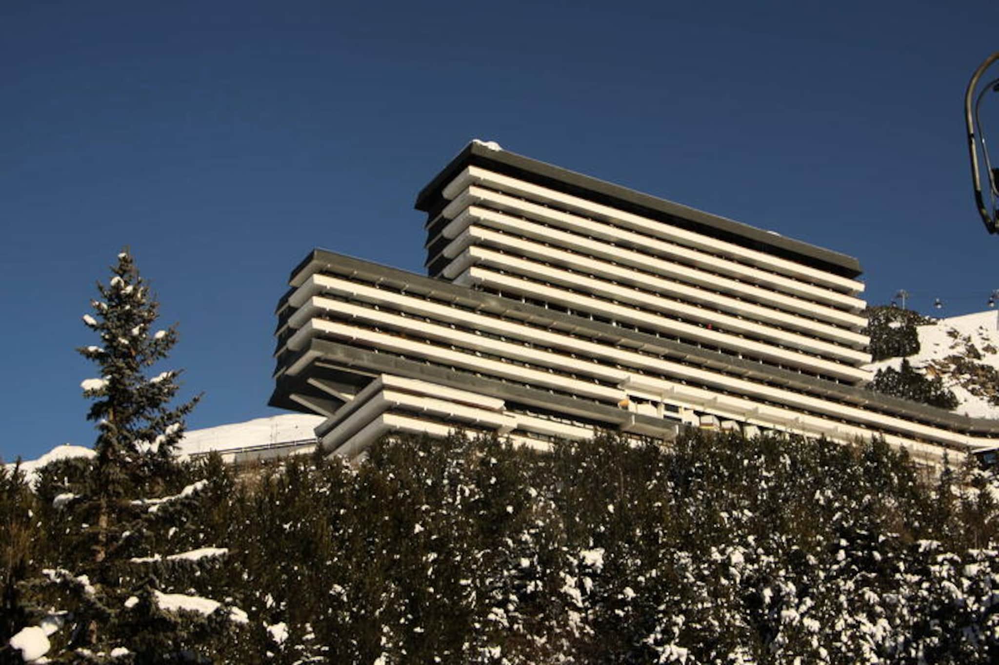 High above the bustling Les Menuires resort, the Brelin building offers a serene retreat with panoramic views and direct access to the slopes. Imagine waking up to the golden glow of the sun streaming through your southwest-facing balcony, overlooking the majestic alpine landscape. With public elevators connecting you to the lively La Croisette district 24/7, you’re perfectly positioned to enjoy both tranquility and convenience in the heart of the French Alps. Whether you’re here for thrilling ski adventures or a peaceful mountain escape, this triplex apartment promises unforgettable moments. \n\nSpanning 55 m², this thoughtfully designed 3-room apartment accommodates up to eight guests, making it ideal for families or groups of friends. The living room features a cozy single bed and pull-out bed, while the two bedrooms offer flexible sleeping arrangements, including a double bed and a combination of single beds with a bunk bed. Please note, the upper bunk is not suitable for children under six years old. The fully equipped kitchen invites you to prepare hearty meals after a day on the slopes, complete with a cooktop, oven, microwave, refrigerator, dishwasher, and essential appliances like a toaster and coffee maker. Modern amenities such as a television and paid Wi-Fi ensure comfort and connectivity during your stay. \n\nConvenience is key at Brelin, with ski lockers located at the ski-in/ski-out level and shops, ticket offices, and free parking at the Nant Benoit lift just steps away. Whether you’re exploring the vibrant La Croisette district or enjoying the exceptional sunshine from your balcony, every moment here is steeped in alpine charm. \n\nChoose this apartment for its unbeatable location, breathtaking views, and cozy ambiance. Whether you’re carving through fresh powder or soaking in the mountain serenity, Brelin is your gateway to an extraordinary alpine experience.