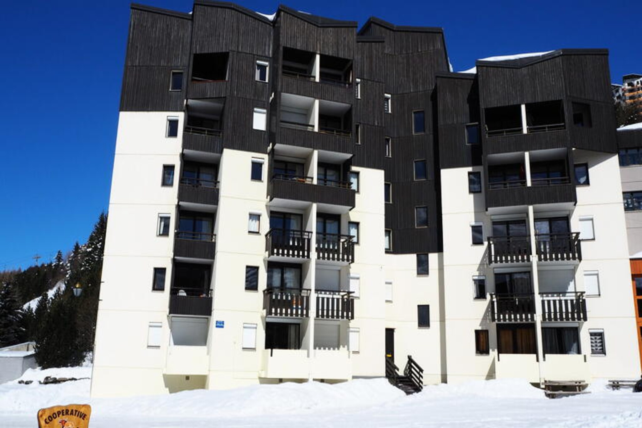 In the heart of the picturesque Place des Bouquetins, this charming apartment offers a cozy alpine retreat just 20 meters from the slopes. Imagine stepping out of your door and being moments away from thrilling ski adventures, all while surrounded by the serene beauty of the French Alps. With its southwest-facing balcony, you can bask in the afternoon sun while enjoying views of the lively square below, creating the perfect setting for relaxation after a day on the mountain. \n\nThis thoughtfully designed 32 m² apartment comfortably accommodates up to five guests, making it ideal for families or small groups. The living room features a sofa bed that converts into a double bed, while the bedroom offers two single bunk beds and an additional single bed. The well-equipped kitchen includes a ceramic hob, grill oven, microwave, refrigerator, dishwasher, and all the essentials for preparing delicious meals. Modern conveniences such as free Wi-Fi, a television, and electric shutters ensure a comfortable and hassle-free stay. The apartment also includes a ski locker for your convenience. \n\nA pedestrian bridge opposite the residence connects you to the vibrant Bruyères district, where you’ll find a variety of restaurants, shops, a cinema, a water park, and a wellness center. Families will appreciate the nearby toboggan run, ski school, and children’s playground. For those looking to explore further, the Croisette district is just a 15-minute walk away via a scenic pedestrian path. \n\nWhether you’re here to carve through fresh powder or simply soak in the alpine charm, this apartment offers a perfect blend of comfort, convenience, and access to the best of Les Menuires. Make unforgettable memories in this delightful mountain escape.