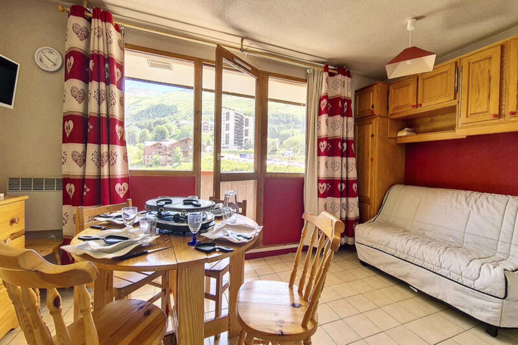 High above the picturesque Preyerand district, this charming studio apartment invites you to experience the magic of the French Alps. With its northeast-facing balcony on the 6th floor, you can wake up to serene mountain views and crisp alpine air, creating the perfect setting for a memorable getaway. Whether you're seeking adventure on the slopes or tranquil moments surrounded by nature, this cozy retreat offers a delightful escape. The Sarvan residence is ideally located at the foot of the slopes, ensuring seamless access to winter sports and scenic trails. A free cable car connects you to the bustling La Croisette district, operating daily from morning until late evening, making it easy to explore the heart of Les Menuires. 
                       Inside, the 21 m² studio is thoughtfully designed to accommodate up to four guests. The living area features a comfortable sofa bed for two, while a separate sleeping alcove offers bunk beds, perfect for families or small groups. The kitchen is fully equipped with modern appliances, including a mini-oven, microwave, dishwasher, and coffee maker, ensuring you can prepare hearty meals after a day of exploration. The tiled flooring adds a touch of practicality, while the bathroom and separate toilet provide convenience for all guests. Pets are welcome for an additional fee, and duvets are provided for added comfort. 
                       Beyond the apartment, you'll find ski lift ticket offices and essential amenities within a five-minute walk, making your stay as effortless as possible. Paid Wi-Fi access is available, subject to coverage, allowing you to stay connected while enjoying your alpine retreat. Whether you're here for the thrill of skiing or the peaceful beauty of the mountains, this studio offers a warm and inviting base for your adventures in Les Menuires.