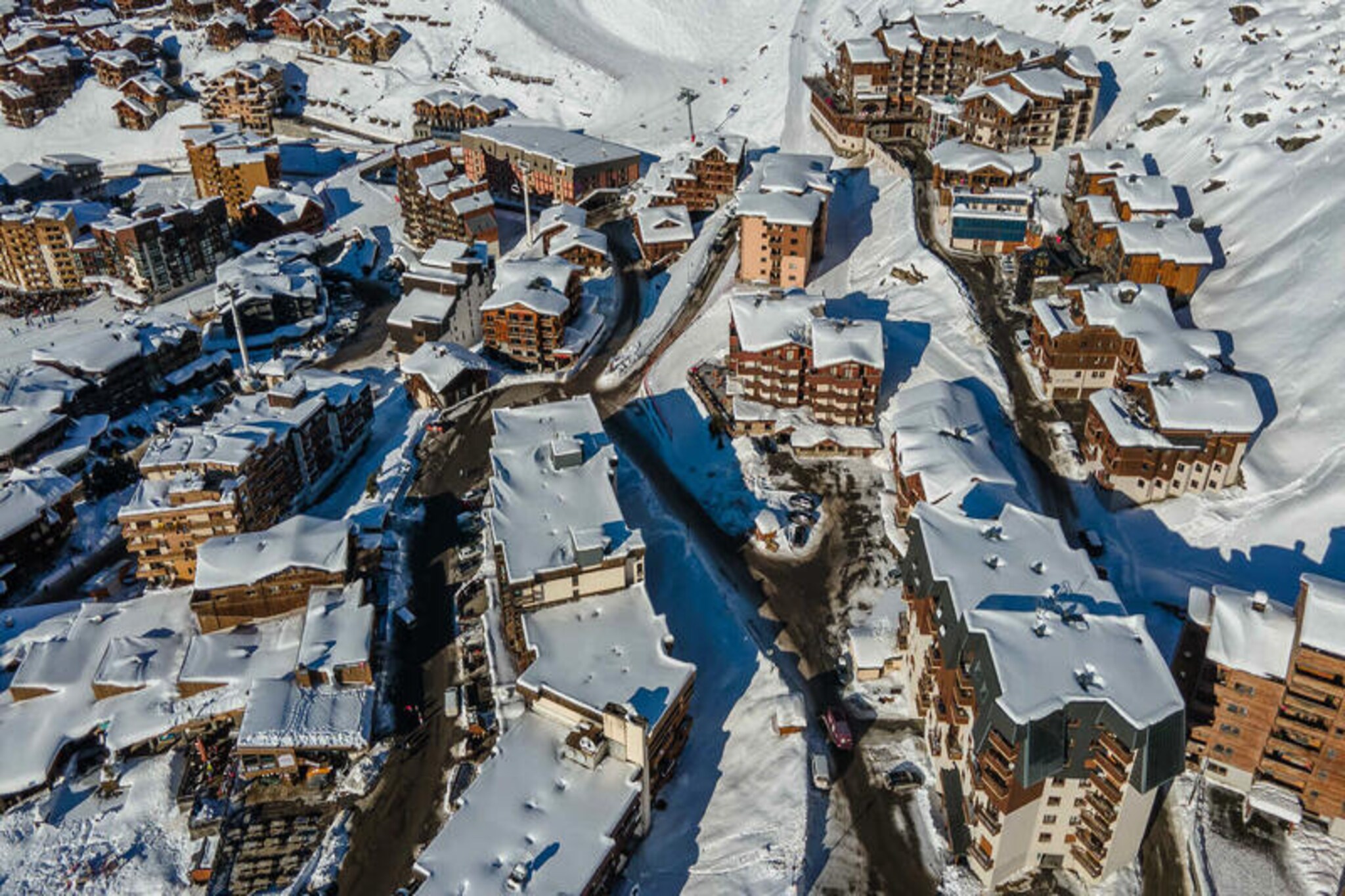 In the vibrant heart of Val Thorens, this spacious apartment offers an exceptional retreat for mountain enthusiasts. Surrounded by the breathtaking peaks of the French Alps, it combines modern comfort with the charm of a world-class ski resort. Whether you're here for thrilling winter sports or serene summer hikes, this property is your gateway to unforgettable alpine adventures. Its proximity to the new Sports Centre ensures easy access to top-notch facilities, making it a perfect base for active travelers. \n\nThe apartment comfortably accommodates up to nine guests, featuring a thoughtfully designed layout across two floors. On the ground floor, you'll find an inviting living area that seamlessly connects to the dining room and fully equipped kitchen, perfect for sharing meals and stories after a day on the slopes. The furnished loggia and enclosed balcony with a foosball table add a playful touch to your stay. Upstairs, two double bedrooms, an alcove with twin beds, and two cozy cabin-style rooms provide ample sleeping arrangements for families or groups of friends. Modern amenities like a boot dryer, Wi-Fi, and a laundry area ensure a hassle-free holiday experience.\n\nStep outside, and you're just moments away from the slopes of one of the world's most renowned ski areas. In addition to skiing, Val Thorens offers a lively après-ski scene, diverse dining options, and a host of activities for all ages. During the summer, the region transforms into a haven for hikers and nature lovers, with trails that showcase the stunning beauty of the Alps. \n\nThis apartment is more than just a place to stay—it's a home base for creating cherished memories in the heart of the mountains. With its unbeatable location, thoughtful amenities, and welcoming atmosphere, your perfect alpine escape awaits.