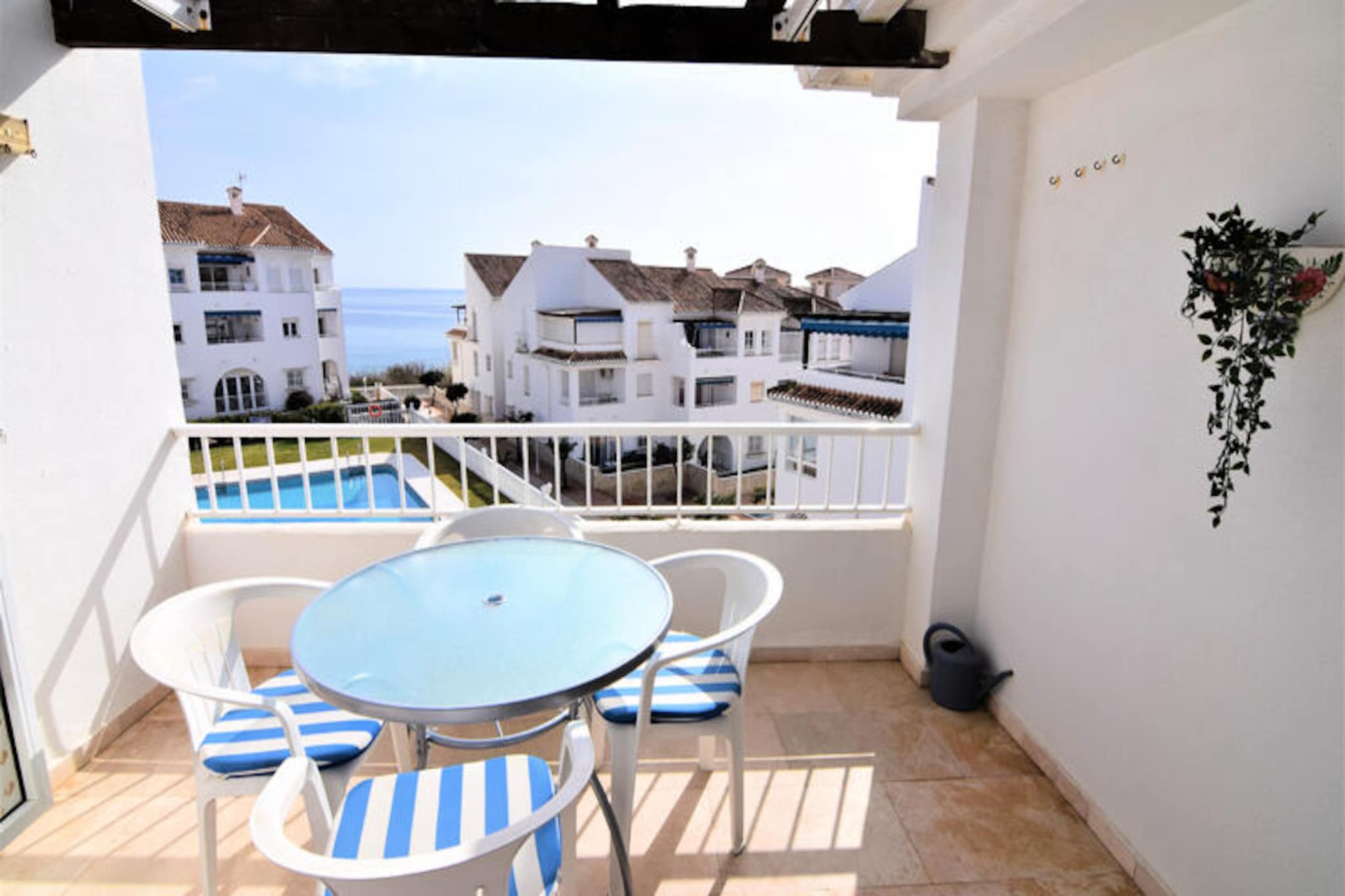 Awaken your senses in the heart of Nerja, where the Mediterranean breeze greets you each morning and the sound of waves creates the perfect soundtrack to your holiday. This charming beachfront apartment invites you to experience the essence of coastal living, with uninterrupted views of the sea and lush gardens that surround the property. Whether you're here to relax or explore, this serene retreat offers a warm and welcoming atmosphere for your stay. 
 
 Inside, the apartment spans 80 m² and is thoughtfully designed to accommodate up to six guests. With two cozy bedrooms, a fully equipped kitchen featuring modern appliances like a dishwasher and washing machine, and a bright living area with air conditioning and Wi-Fi, every detail has been considered for your comfort. Step out onto the private terrace to enjoy your morning coffee or unwind in the shared swimming pool, open year-round for a refreshing dip. The property also includes a TV and all the essentials for a stress-free holiday.
 
 Located just steps from Playa La Torrecilla, you'll find sandy shores and rocky coves perfect for sunbathing or snorkeling. The vibrant town center of Nerja is only a short walk away, offering a delightful mix of local restaurants, shops, and cultural attractions. For nature enthusiasts, the nearby Acantilados de Maro-Cerro Gordo natural park and Río Chillar provide stunning hiking trails and breathtaking scenery. Families will love the proximity to Aquatropic water park and Tivoli World amusement park, while golf enthusiasts can tee off at Baviera Golf just 38 km away.
 
 Whether you're seeking a tranquil escape by the sea or an adventure-filled getaway, this apartment in Nerja is your gateway to unforgettable memories. With its unbeatable location and thoughtful amenities, it’s the perfect choice for families, couples, or friends looking to experience the magic of Spain’s Costa del Sol.
