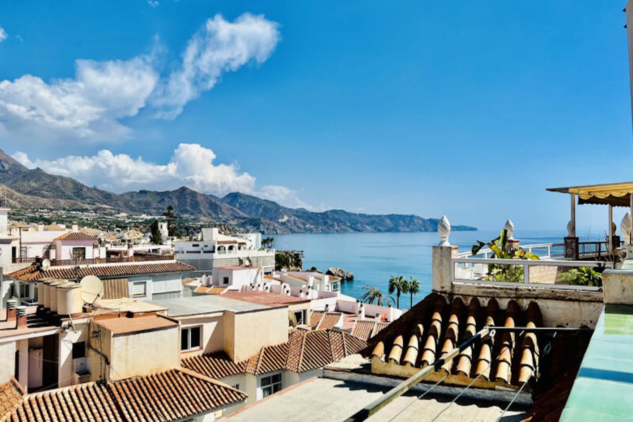 Imagine waking up to the gentle Mediterranean breeze and stepping out onto a private terrace with sweeping views of the sea, the mountains, and the charming town of Nerja. This top-floor one-bedroom apartment in the Sirena building is a sunlit haven, perfect for up to four guests seeking a serene yet central retreat. Located just 400 meters from the golden sands of Torrecilla Beach, this property offers the ideal blend of relaxation and convenience. 
 
 Inside, the apartment is bright and inviting, with a spacious living and dining area that opens to the terrace, a fully equipped separate kitchen, and a cozy bedroom designed for restful nights. Modern amenities such as air conditioning for both heating and cooling, satellite TV, and free Wi-Fi ensure a comfortable stay. The building is equipped with two elevators for easy access, making it suitable for all travelers. 
 
 Step outside, and you’ll find yourself in the heart of Nerja, surrounded by a vibrant array of shops, restaurants, bars, and local attractions. Whether you’re strolling along the picturesque streets or enjoying the nearby beaches, everything you need is within walking distance. For those seeking a touch of indulgence, booking this accommodation grants you access to the exclusive Club Nerja Spa. Located in the tranquil San Juan de Capistrano area, the spa offers a rejuvenating experience with its heated pool, Roman bath, jacuzzi, sauna, and hammam. For just €25 per person, you can elevate your holiday into a wellness escape. 
 
 Whether you’re here to soak up the sun, explore the beauty of Andalusia, or simply unwind in a peaceful setting, this apartment is your gateway to an unforgettable Mediterranean getaway.