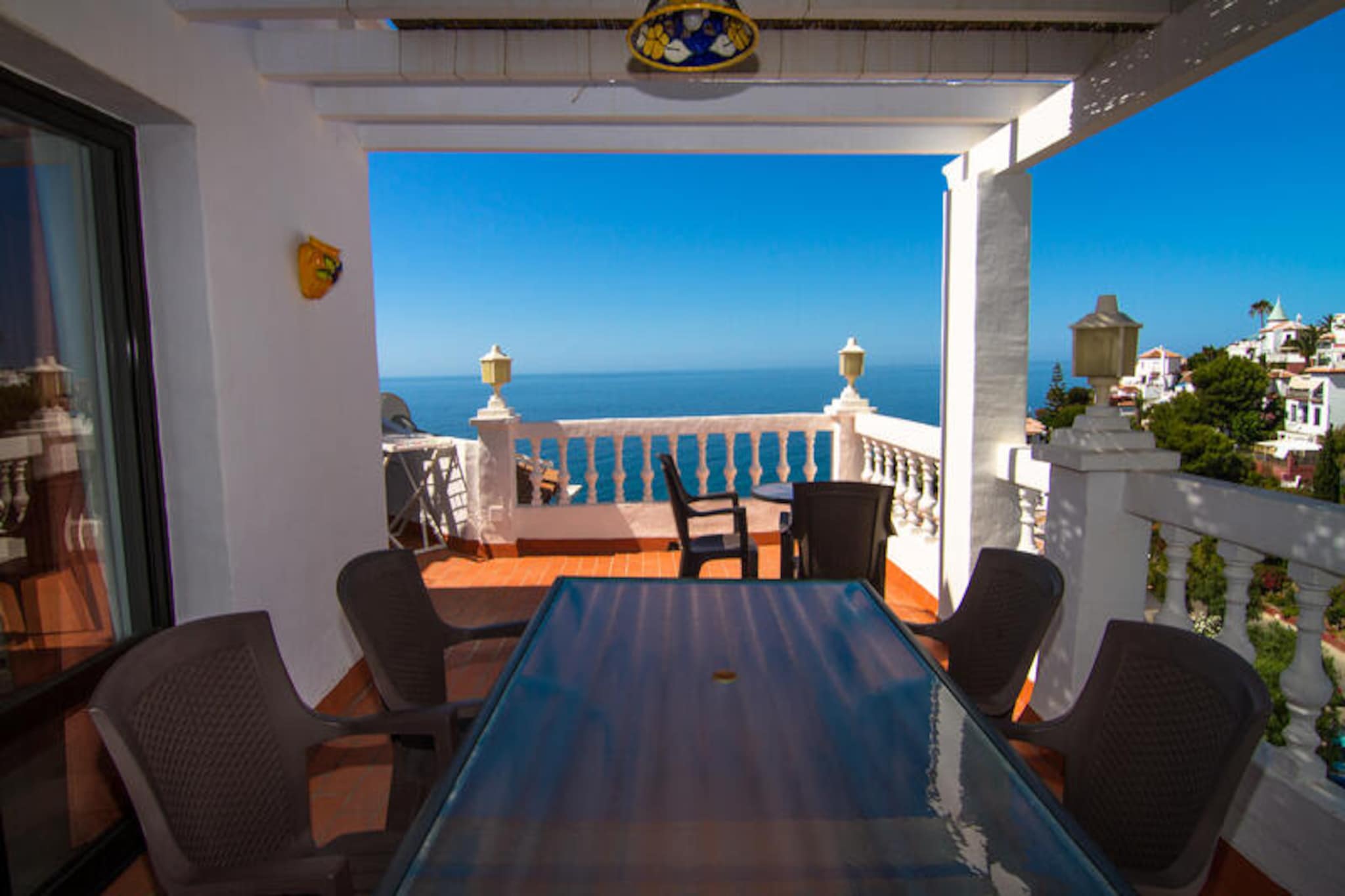 Perched on a hillside overlooking the sparkling Mediterranean, this two-bedroom, two-story apartment in the exclusive Ladera del Mar urbanization offers a serene coastal retreat with breathtaking sea views. The tranquil setting, surrounded by lush gardens and the gentle sound of the waves, invites you to unwind and embrace the beauty of southern Spain. From the moment you step onto the expansive southwest-facing terrace, you’ll be captivated by the endless blue horizon and the golden glow of the setting sun.
Inside, the apartment is thoughtfully designed for comfort and convenience. The ground floor features a fully equipped kitchen with modern appliances, a cozy bedroom, a bathroom, and a spacious living/dining area with a sofa bed. Step outside to the terrace, complete with a barbecue, perfect for al fresco dining. Upstairs, you’ll find another bedroom, a bathroom, a small drying terrace, and two additional terraces, including a large southwest-facing one that offers panoramic sea views. With free Wi-Fi, 190 international TV channels, and a washing machine, every detail has been considered to make your stay as comfortable as possible.
The Ladera del Mar complex is a haven of peace and beauty, with a stunning communal pool and sunbathing area surrounded by vibrant greenery. The beaches are just 500 meters away, and the charming town center of Nerja is only a few minutes’ drive, offering a variety of shops, restaurants, and cultural attractions. Parking is convenient and accessible within the complex.
As a special bonus, your booking includes access to the exclusive CLUB NERJA SPA, where you can rejuvenate with a luxurious circuit of Roman baths, a heated pool, a jacuzzi, a sauna, and a hammam. Whether you’re seeking relaxation, adventure, or a mix of both, this property promises an unforgettable Mediterranean escape.