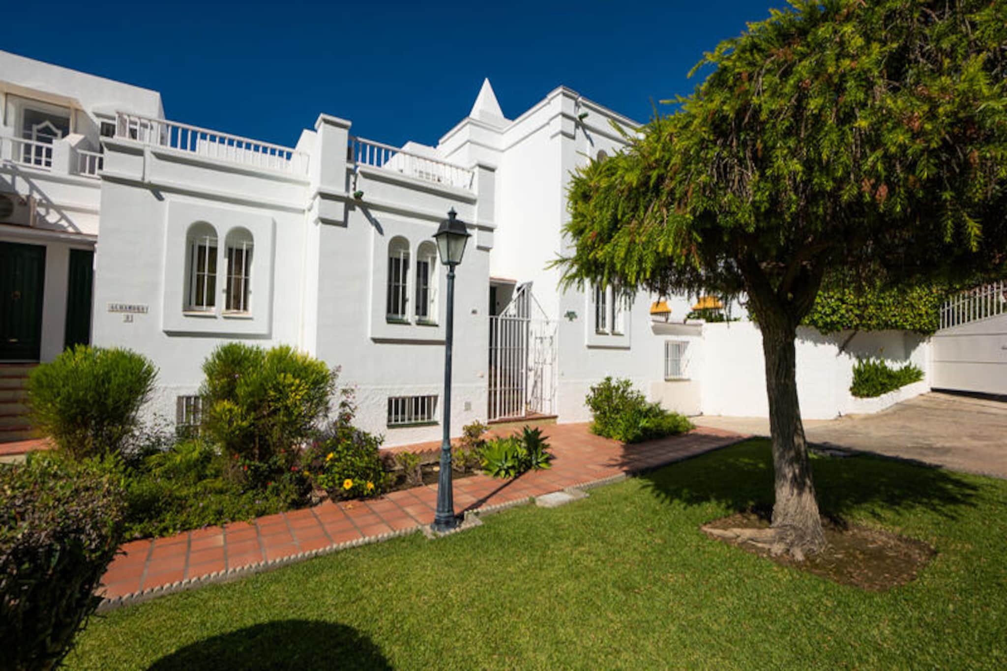 Imagine waking up to the gentle Mediterranean breeze and stepping out onto one of your four private terraces to soak in the panoramic views of the sea and surrounding mountains. This charming townhouse, located in the tranquil Alhambra III urbanization in the northeast of Nerja, offers the perfect blend of comfort and serenity. With its modern design and lush green surroundings, it’s an ideal retreat for families or groups seeking a peaceful getaway just minutes from the vibrant heart of Nerja and its stunning beaches. 

The recently renovated property boasts three spacious bedrooms, all equipped with air conditioning for year-round comfort, and a cozy living room with free Wi-Fi and a TV featuring 160 channels. The fully equipped separate kitchen makes preparing meals a delight, while the private garden with a barbecue invites you to dine al fresco under the Andalusian sun. Two modern bathrooms and multiple terraces ensure plenty of space for everyone to relax and unwind. The communal swimming pool, surrounded by well-maintained gardens, is open year-round, offering a refreshing escape no matter the season. 

As an added bonus, your stay includes access to the exclusive Nerja Spa Club, located in the nearby San Juan de Capistrano urbanization. For just €25 per person, indulge in the luxurious 5-element circuit featuring a heated pool, Roman bath, jacuzzi, sauna, and hammam, transforming your holiday into a rejuvenating experience. 

Whether you’re exploring the charming streets of Nerja, lounging on its golden beaches, or enjoying the tranquility of your private retreat, this townhouse offers the perfect base for an unforgettable holiday on Spain’s Costa del Sol.