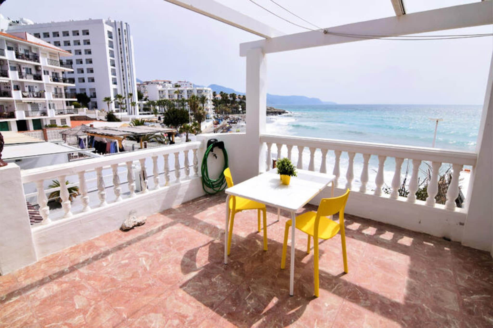 Awaken your senses to the soothing rhythm of the Mediterranean in this charming beachfront apartment in Nerja. With the golden sands of Playa Torrecilla and the rugged beauty of Playa El Chucho just steps away, this retreat offers a harmonious blend of coastal tranquility and vibrant local life. Whether you're sipping your morning coffee on the private 10 m² terrace or strolling to nearby restaurants, the sea breeze and stunning views will make every moment unforgettable.
Inside, the apartment is tastefully furnished, featuring two cozy bedrooms and enough space to comfortably accommodate up to six guests. The open-plan American-style kitchen, equipped with modern appliances such as a ceramic hob, oven, and coffee maker, invites you to prepare meals with fresh local ingredients from the nearby supermarket. Relax in the spacious living area with satellite TV or take advantage of the communal swimming pool, perfect for cooling off after a day of exploring.
The location is unbeatable. A short walk brings you to a variety of restaurants, shops, and the lively town center. For nature enthusiasts, the breathtaking cliffs of Maro-Cerro Gordo Natural Park are just 5 km away, while the serene Rio Chillar offers picturesque hiking trails. Families will love the proximity to Aqua Tropic water park and Tivoli World amusement park, while golfers can tee off at Baviera Golf, just 38 km away.
Whether you're seeking a romantic getaway, a family holiday, or an adventure-filled escape, this apartment in Nerja is your gateway to the best of the Costa del Sol. Let the charm of this seaside haven create memories you'll cherish forever.