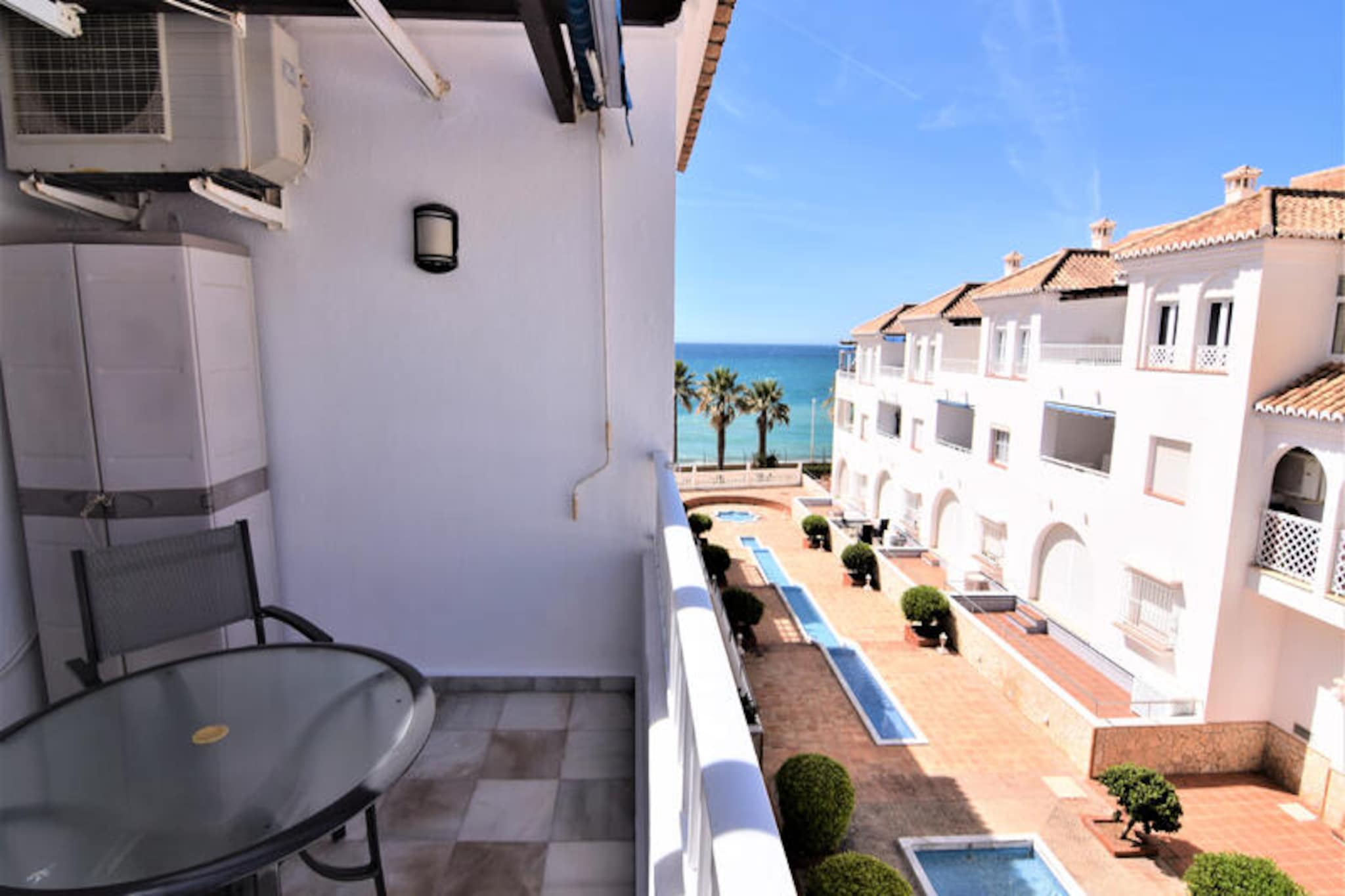 In the heart of Nerja, where the charm of Andalusian streets meets the sparkling Mediterranean, this delightful apartment offers a serene coastal escape. Imagine waking up to the gentle sound of waves, stepping out onto your private terrace, and feeling the warmth of the Spanish sun as you plan your day in this picturesque seaside town. Whether you're seeking relaxation or adventure, this property is the perfect starting point for unforgettable memories. 
 
 The apartment comfortably accommodates up to four guests in its two well-appointed bedrooms, making it ideal for couples or small families. The modern 70 m² interior is thoughtfully designed with comfort in mind, featuring a cozy living area, air conditioning, and a fully equipped kitchen with everything you need to prepare delicious meals. From a dishwasher to a juicer, every detail has been considered. After a day of exploring, unwind in the communal swimming pool or enjoy your favorite shows on the satellite TV with channels in multiple languages. 
 
 Just 50 meters away, you'll find the golden sands of Playa Torrecilla, perfect for sunbathing or a refreshing swim. Stroll through Nerja's vibrant streets, where charming restaurants and cafés invite you to savor local delicacies. For nature enthusiasts, the breathtaking cliffs of Maro-Cerro Gordo Natural Park are just a short drive away, offering hiking trails and stunning views. Other nearby attractions include the Chillar River, Aquavelis Water Park, and Baviera Golf Course, ensuring there's something for everyone. 
 
 Whether you're drawn by the allure of the sea, the rich cultural heritage, or the promise of relaxation, this apartment in Nerja is your gateway to an unforgettable Andalusian retreat.
