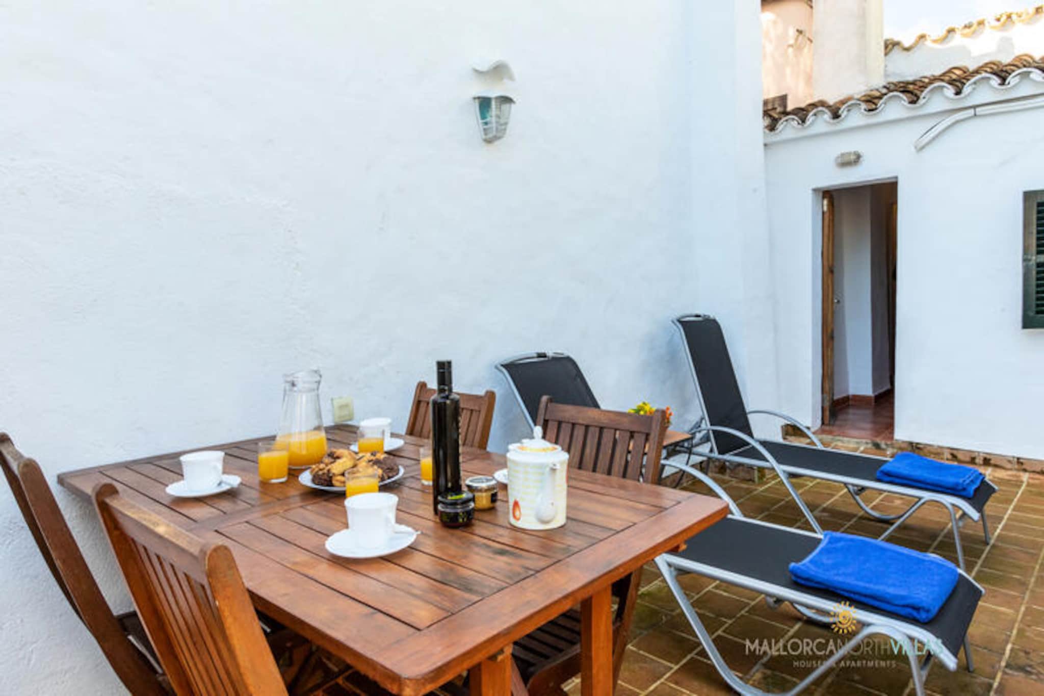 In the heart of Pollensa, where cobbled streets wind through a tapestry of Mallorcan charm, Joana House offers a serene retreat for up to four guests. This delightful village home invites you to immerse yourself in the authentic rhythms of local life, just a short stroll from the bustling main square with its vibrant cafes and markets. Wake up to the gentle sounds of the village and savor the view of Puig de Maria from the sun-drenched terrace.
Inside, the house blends traditional character with modern comfort. The ground floor features a cozy living room leading to a dining area, perfect for intimate meals. The compact yet well-equipped kitchen includes a microwave, dishwasher, and all essential utensils for preparing delicious Mediterranean dishes. A small courtyard adds a touch of outdoor charm, while the laundry room and full bathroom with a bathtub ensure convenience during your stay.
Upstairs, the sleeping quarters promise restful nights with air conditioning and heat pumps. The master bedroom boasts a king-size bed and en-suite bathroom, while the second bedroom offers twin beds, ideal for families or friends. Step outside to the barbecue terrace, where you can bask in the Mallorcan sunshine or enjoy al fresco dining under the stars.
With free Wi-Fi, satellite TV, and thoughtful amenities like beach towels, a cot, and high chair, Joana House caters to every detail for a carefree holiday. Whether exploring Pollensa’s historic sites, hiking Puig de Maria, or relaxing on nearby beaches, this charming home is your gateway to the beauty of Mallorca.