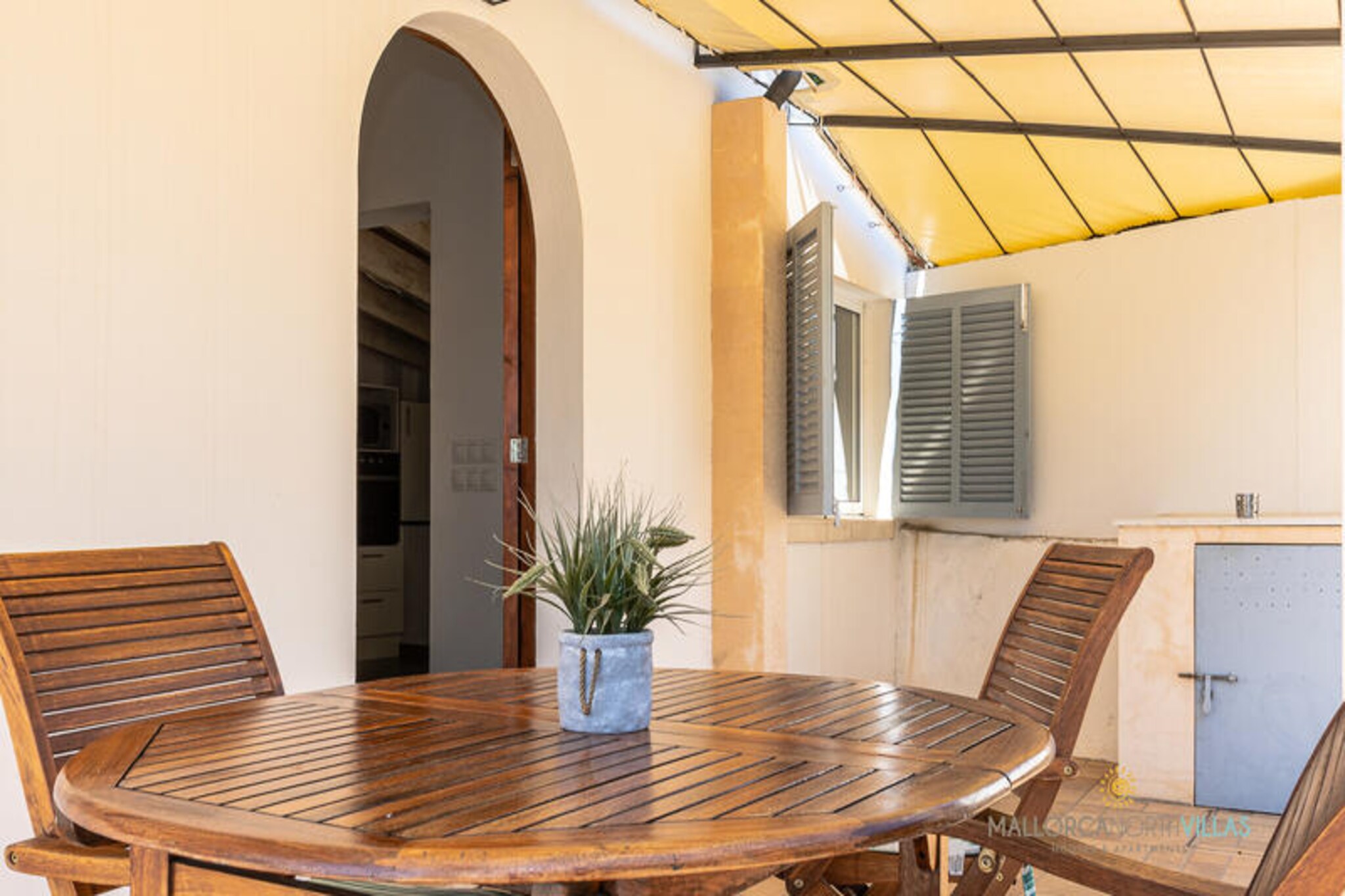 Amidst the serene beauty of the Serra de Tramuntana, Villa Les Oliveres Petites offers an idyllic retreat for couples seeking tranquility and charm. Surrounded by olive groves and Mediterranean greenery, this 70 m² villa invites you to unwind in a natural haven where the gentle rustle of leaves and mountain views set the tone for relaxation. The property’s private estate ensures peace and privacy, making it the perfect escape for romantic getaways or quiet reflection. \n\nStep outside to discover a lush garden adorned with native trees and a manicured lawn. The sun terrace, complete with loungers, beckons for lazy afternoons under the Mallorcan sun, while the shaded porch and outdoor dining area are ideal for savoring meals al fresco. A built-in barbecue adds a touch of rustic charm, perfect for sunset dinners. The villa also boasts private parking, ensuring convenience for those eager to explore the nearby treasures of Pollença and beyond. \n\nInside, the villa combines traditional Majorcan aesthetics with modern amenities. The cozy living space features air conditioning, a wood-burning stove for cooler evenings, Wi-Fi, and satellite TV. The Mediterranean-inspired decor complements the fully equipped kitchen, which includes essentials like a ceramic hob, oven, microwave, and dishwasher. The double bedroom and modern bathroom provide comfort and simplicity, while families with infants can benefit from the complimentary cot upon request. \n\nLocated just a short drive from Pollença’s vibrant town center, pristine northern beaches, and scenic mountain trails, Villa Les Oliveres Petites is perfectly positioned for exploration. Whether you’re hiking through the Tramuntana, cycling through the countryside, or simply soaking in the peaceful ambiance, this villa promises an unforgettable Mallorcan experience.