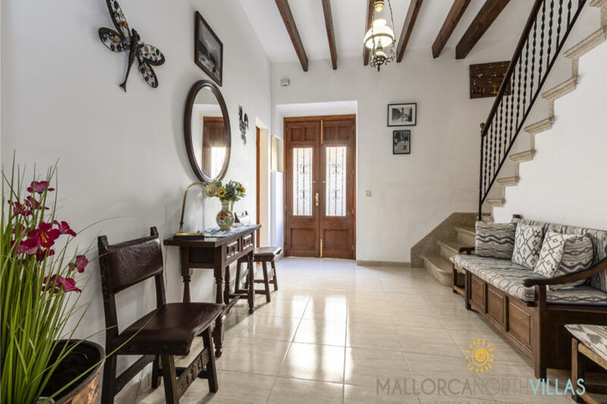 Step into the timeless charm of Maison Guillermo, a beautifully restored Mallorcan home nestled on a quiet pedestrian street in the heart of Pollença's historic center. This enchanting village in northern Mallorca is renowned for its cobblestone streets, artisan boutiques, and vibrant culinary scene, making it the perfect destination for an authentic Mediterranean escape. Whether you're strolling through the nearby art galleries or savoring a glass of wine at a local café, the atmosphere here is nothing short of magical. \n\nThe property itself is a harmonious blend of traditional character and modern comfort. Spanning three floors, Maison Guillermo features three spacious double bedrooms, two contemporary bathrooms, and a bright living and dining area that invites relaxation. The fully equipped kitchen, complete with a dishwasher, oven, and coffee maker, is perfect for preparing meals with fresh local ingredients. Upstairs, you'll find a private terrace with a barbecue and retractable awning, ideal for al fresco dining or unwinding under the Mallorcan sun. Air conditioning in every room, free Wi-Fi, and secure bicycle storage ensure a comfortable and convenient stay for all guests. \n\nLocated just 10 km from the pristine beaches of Cala San Vicente and Pollensa Bay, and 40 km from Palma Airport, this home offers unparalleled access to the best of Mallorca. Explore the surrounding shops, art galleries, and renowned restaurants, or venture out on scenic cycling routes that wind through the island's breathtaking landscapes. \n\nWhether you're seeking a tranquil retreat or an active holiday, Maison Guillermo provides the perfect base to experience the authentic essence of Mallorca. Let the charm of Pollença and the comfort of this exceptional property create memories you'll treasure forever.