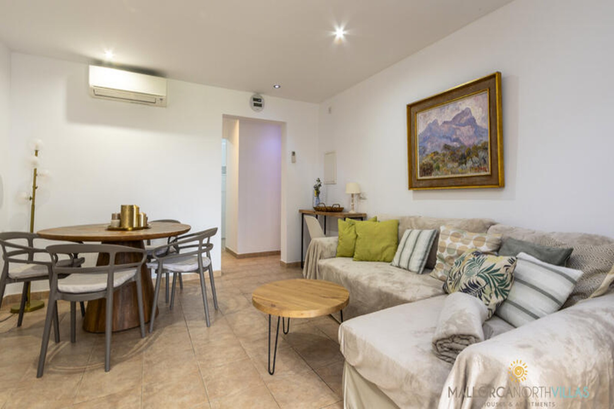 Step into a world of Mediterranean charm with this bright and inviting ground-floor apartment in the exclusive Club del Sol area of Port de Pollensa, Mallorca. Surrounded by lush gardens and just steps from the shimmering sea, this property offers the perfect blend of tranquility and convenience for your next holiday. Imagine waking up to the gentle sea breeze and enjoying your morning coffee on your private terrace while the sun rises over the garden. This is where relaxation meets effortless coastal living. \n\nInside, the apartment boasts two comfortable double bedrooms and a modern bathroom with a sleek shower. The spacious living and dining area is bathed in natural light, thanks to large bay windows that open onto the terrace. A fully equipped separate kitchen makes it easy to prepare meals, whether you’re indulging in local Mallorcan delicacies or enjoying a quiet dinner at home. With air conditioning in all rooms, free Wi-Fi, and satellite TV, every detail has been designed for your comfort and convenience. The communal pool is a refreshing retreat, perfect for unwinding after a day of exploring. \n\nLocated in a peaceful residential area, this apartment is ideal for both relaxation and adventure. The bus stop is just 100 meters away, and the vibrant center of Puerto de Pollensa is only 1 km from your doorstep. For beach lovers, the area’s longest sandy stretches are just 2 km away, offering endless opportunities for sunbathing, swimming, and water sports. With everything so close, you won’t even need a car to experience the best of this enchanting destination. \n\nWhether you’re seeking a romantic getaway or a family escape, this apartment is your gateway to the magic of Mallorca. Book now and let the beauty of Puerto de Pollensa create memories that will last a lifetime.