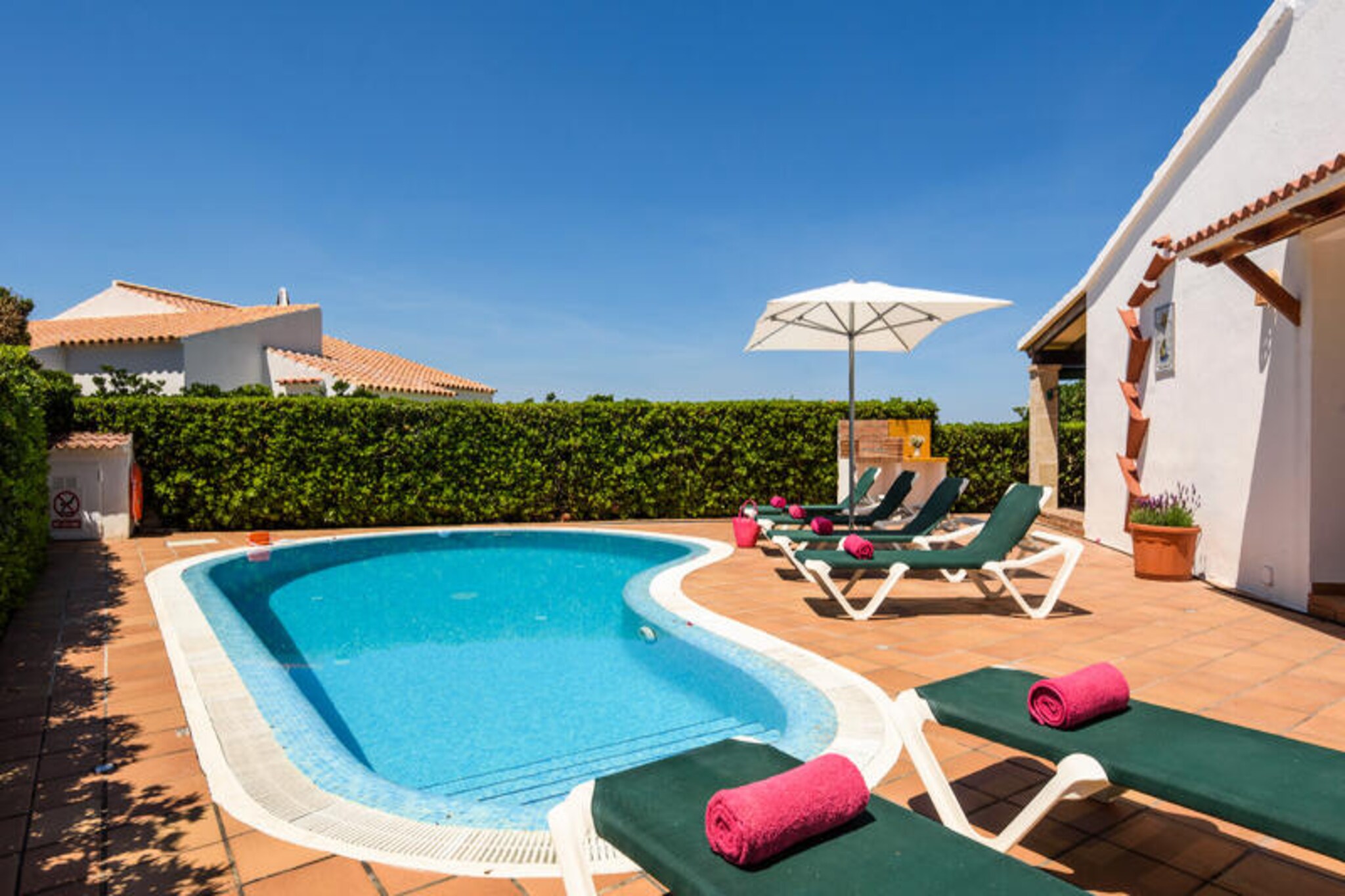 Bathed in the golden Mediterranean light, this charming villa in Cap d'Artruix offers an idyllic retreat for families and groups of up to eight guests. With its spacious layout and serene garden views, this 160 m² property invites you to unwind and savor the beauty of Menorca’s coastal charm. Whether you’re lounging by the private pool or enjoying a meal on the terrace, every corner of this villa is designed for relaxation and comfort. \n\nInside, the villa boasts four bright and airy bedrooms, complemented by modern amenities such as Wi-Fi, satellite TV with international channels, and air conditioning in select rooms. The fully equipped kitchen, featuring a ceramic cooktop, dishwasher, and coffee maker, makes it easy to prepare delicious meals to enjoy al fresco. The villa also includes a washing machine, barbecue, and garden furniture, ensuring all the conveniences of home are at your fingertips. \n\nPerfectly located, the villa is just 400 meters from the Bettabuy supermarket and 1 kilometer from the family-friendly AquaRock water park. For beach lovers, the sandy shores of Calan Bosch are only 2 kilometers away, while the stunning Calan Brut rock beach is a short 13-meter stroll. The picturesque Lago de Calan Bosch, lined with a variety of restaurants, is also within easy reach, offering delightful dining options. Golf enthusiasts can explore the Golf Son Parc Menorca course, 44 kilometers away, while Menorca Airport is just 53 kilometers from the property. \n\nWhether you’re seeking sun-soaked days by the pool, adventures along Menorca’s pristine coastline, or tranquil evenings under the stars, this villa provides the perfect setting for an unforgettable Mediterranean getaway.