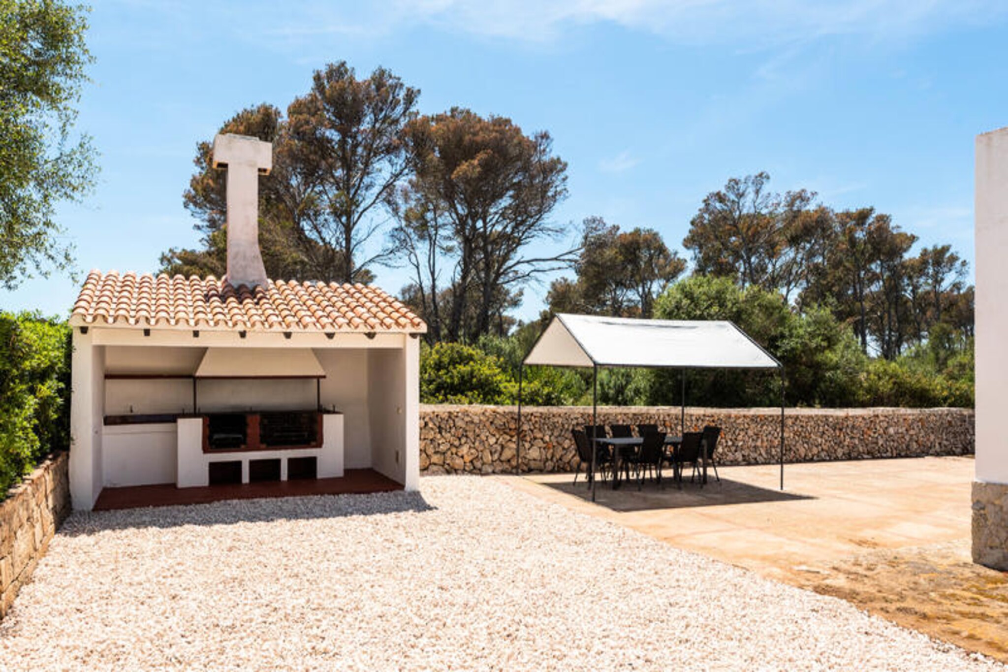 Surrounded by lush Mediterranean woods, this charming villa in Cala Blanca offers a serene retreat for families and groups seeking relaxation and adventure on the picturesque island of Menorca. The property’s tranquil setting combines the beauty of nature with the convenience of nearby amenities, creating an idyllic escape where you can unwind and reconnect with loved ones. Whether you’re lounging by the private pool or enjoying the warm breeze on the terrace, every moment here feels like a celebration of island life. \n\nSpanning 120 m², the villa comfortably accommodates up to seven guests across its four inviting bedrooms. Designed with comfort and practicality in mind, the property boasts modern amenities such as Wi-Fi, air conditioning, and satellite TV with Spanish and English channels. The spacious living area is perfect for gathering, while the fully equipped kitchen—complete with a ceramic hob, dishwasher, and citrus juicer—makes meal preparation a breeze. Outdoors, the fenced garden and barbecue area invite you to savor al fresco dining under the stars. \n\nCala Blanca’s stunning beaches and crystalline waters are just moments away, offering endless opportunities for swimming, snorkeling, and sunbathing. Explore the nearby trails that wind through the fragrant pine forests or venture into the charming local town for a taste of Menorca’s rich culture and cuisine. With its blend of natural beauty and modern comforts, this villa is the perfect base for discovering the island’s hidden gems. \n\nWhether you’re seeking a peaceful retreat or an active holiday, this villa in Cala Blanca promises an unforgettable experience filled with relaxation, exploration, and cherished memories.