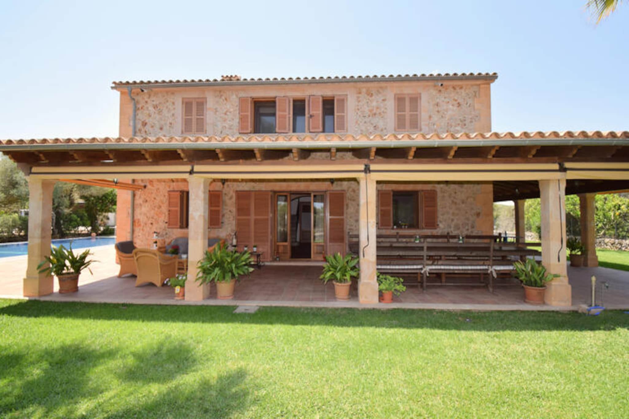 Amid the serene beauty of northern Mallorca, this spacious villa invites you to experience a perfect blend of relaxation and Mediterranean charm. Surrounded by lush gardens and sun-drenched terraces, the property offers a tranquil retreat where you can unwind and savor the island’s idyllic atmosphere. Whether you’re enjoying a refreshing dip in the private pool or dining al fresco under the stars, every moment here feels like a celebration of Mallorca’s natural splendor. The villa’s thoughtful design and picturesque setting make it an ideal escape for families or groups seeking comfort and authenticity. \n\nInside, the villa spans two levels, each designed for comfort and convenience. The ground floor features a fully equipped open-plan kitchen and a spacious living-dining area with a cozy fireplace, perfect for gathering after a day of exploration. A bedroom and bathroom complete this level. Upstairs, you’ll find a welcoming lounge area, three additional bedrooms, and two bathrooms, all furnished with care to ensure a restful stay. Modern amenities and tasteful décor create a warm and inviting ambiance throughout the home. \n\nLocated near the charming village of Muro, the villa is perfectly positioned to explore the region’s treasures. Stroll through cobbled streets, admire traditional Mallorcan architecture, and indulge in local culinary delights. The nearby beaches offer pristine sands and crystal-clear waters, while the surrounding countryside provides opportunities for hiking and cycling. Whether you’re seeking adventure or relaxation, Muro’s authentic charm will captivate you. \n\nChoose this villa for an unforgettable Mallorcan getaway, where every detail has been crafted to ensure your comfort and enjoyment. From the sparkling pool to the peaceful terraces, this property is your gateway to the magic of Mallorca.