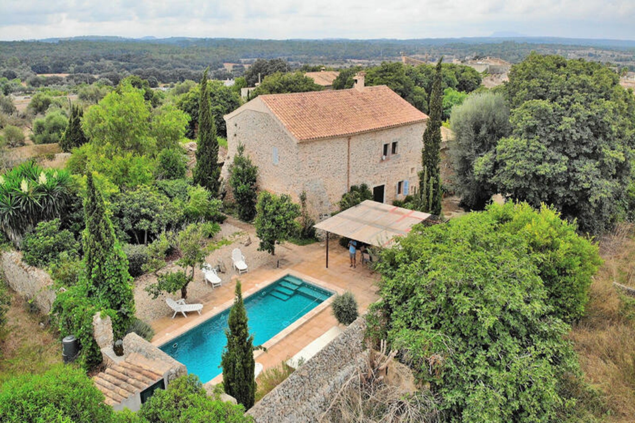 Amid the sun-soaked landscapes of Mallorca, this enchanting stone villa in Llubá invites you to experience the perfect blend of rustic charm and modern comfort. Surrounded by the serene beauty of the island, this property offers a tranquil escape where every detail has been thoughtfully designed to ensure a memorable stay. Whether you're lounging by the sparkling pool or enjoying a quiet moment in one of the shaded terraces, the ambiance here is nothing short of magical. Llubá’s authentic village charm adds a unique touch to your holiday, making it an ideal retreat for families or groups of friends seeking relaxation and connection. \n\nInside, the villa boasts a warm and inviting atmosphere with its traditional Mallorcan decor and high-quality furnishings. The ground floor welcomes you with a spacious living and dining area, perfect for gathering after a day of exploration. A separate, fully equipped kitchen ensures you have everything needed to prepare delicious meals. With four bedrooms and three bathrooms, the property comfortably accommodates up to eight guests. Upstairs, you’ll find additional bedrooms that offer privacy and comfort, while the ground floor features a convenient laundry room and bathroom. \n\nStep outside to discover a true oasis. The villa’s outdoor spaces include multiple terraces, a chill-out area, and a covered seating area ideal for morning coffee or evening drinks. The swimming pool invites you to cool off under the Mallorcan sun, while the barbecue and large dining table set the stage for unforgettable meals shared with loved ones. \n\nLocated in the heart of Llubá, you’ll be close to charming squares, local markets, and stunning beaches, all within easy reach. Whether you’re exploring the natural beauty of Mallorca or simply unwinding in the peaceful surroundings of the villa, this property offers an unparalleled island experience. Make your next holiday truly special in this captivating Mallorcan retreat.