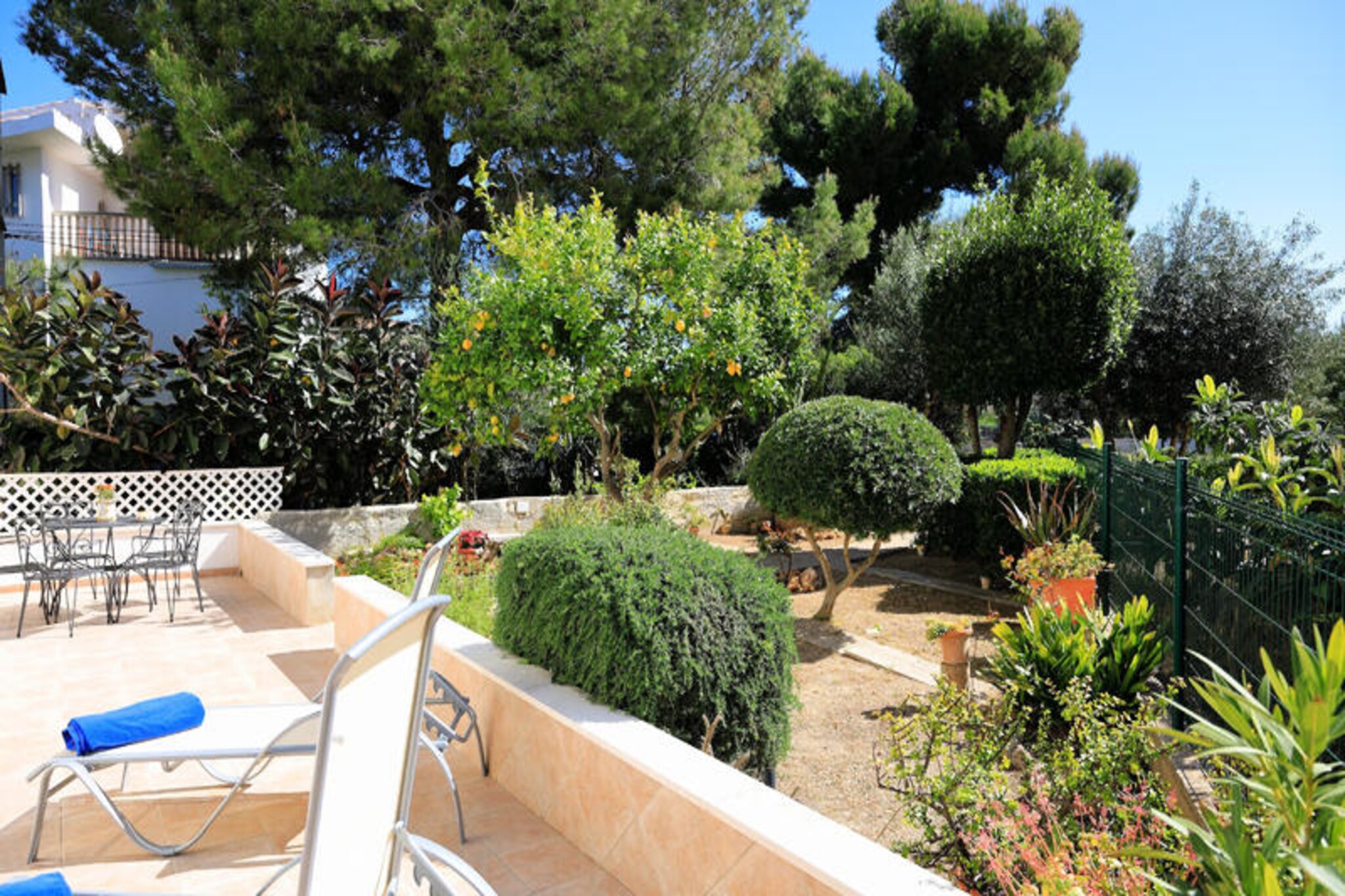 Imagine waking up to the soothing sound of waves and stepping outside to breathtaking views of Pollensa Bay. This charming chalet, just 100 meters from the sea, is a haven for those seeking tranquility and natural beauty. Located in the exclusive Es Barcares neighborhood, it offers a perfect blend of coastal serenity and proximity to the historic town of Alcúdia, just a 5-minute drive away. Known for its excellent kitesurfing conditions, Es Barcares is a favorite among water sports enthusiasts and nature lovers alike. \n\nSpanning 150 m², the chalet comfortably accommodates up to six guests. The spacious living room, adorned with tasteful furnishings, features satellite TV, a DVD player, and Wi-Fi, ensuring both relaxation and entertainment. The fully equipped kitchen invites you to create Mediterranean-inspired meals, perhaps with fresh produce from Alcúdia’s vibrant weekly market. Adjacent to the kitchen, a 25 m² balcony with a dining area provides the perfect setting for al fresco meals with stunning sea views. Three double bedrooms, two bathrooms with showers, and a thoughtful layout ensure comfort and convenience for all guests.\n\nStep outside to discover a 40 m² terrace and an expansive 800 m² garden, lush with Mediterranean plants and a manicured lawn. A built-in barbecue invites you to enjoy leisurely outdoor meals, while a dedicated space for bicycle storage caters to active travelers. Whether you’re lounging in the garden or exploring the nearby coastline, this property offers a seamless blend of relaxation and adventure.\n\nWith its prime location near Alcúdia’s medieval charm, crystal-clear beaches, and vibrant cultural scene, this chalet is the ideal base for an unforgettable Mallorcan escape. Whether you’re seeking water sports, historical exploration, or simply a peaceful retreat, this home promises a holiday to remember.
