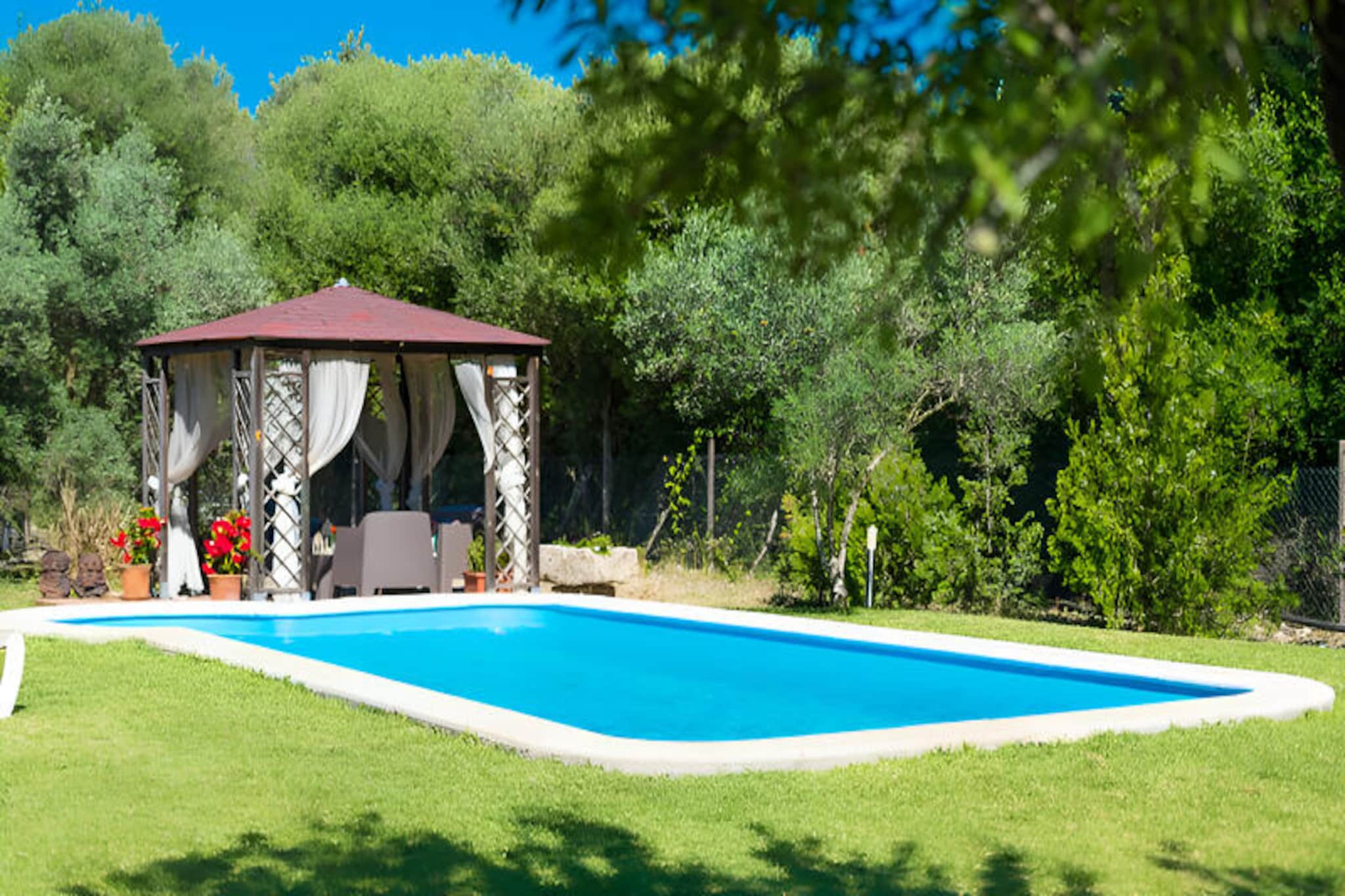 In the heart of Mallorca's serene countryside, this charming family retreat offers a perfect blend of comfort, relaxation, and outdoor fun. Surrounded by lush gardens and Mediterranean charm, this property is an idyllic escape for families or small groups seeking a peaceful getaway. The warm ambiance of the home invites you to unwind and create cherished memories under the Spanish sun.
Inside, the house is thoughtfully designed to accommodate up to four guests. The living room, with its cozy sofas, television, and internet access, is a welcoming space to relax after a day of exploration. The main floor features a lovely bedroom with a double bed, a dining area with an integrated kitchen, and a spiral staircase leading to a second bedroom with two single beds. Two bathrooms, one with a shower and the other with a bathtub, ensure convenience for all guests.
The outdoor area is a true highlight, offering a large terrace with multiple seating areas, perfect for al fresco dining or simply enjoying the tranquil surroundings. The fully equipped outdoor kitchen and barbecue area make it easy to prepare delicious meals while taking in the view of the expansive garden. Children will delight in the playground with a swing and sandbox, while adults can relax by the large swimming pool, complete with sun loungers for ultimate comfort.
Located near the historic village of Alcúdia, this property provides easy access to cobbled streets, ancient walls, and a vibrant local market. With pristine beaches and crystal-clear waters just a short drive away, this home is an excellent base for exploring the beauty and culture of Mallorca. Whether you’re seeking adventure or relaxation, this property promises an unforgettable holiday experience.