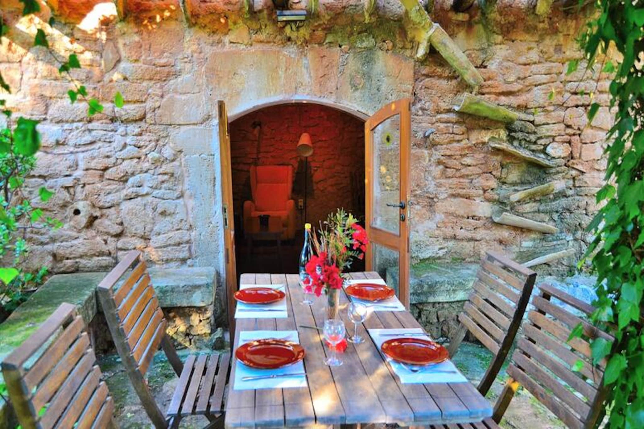 Amidst the serene landscapes of Mallorca, this charming farmhouse near Alcúdia offers a perfect blend of rustic charm and modern comfort. Surrounded by lush gardens and stunning mountain views, it’s a haven for those seeking tranquility and authentic island living. Imagine waking up to the gentle sound of birdsong, enjoying breakfast on the terrace adorned with vibrant flowerbeds, and soaking in the peaceful ambiance of this idyllic retreat. Whether you’re planning a romantic getaway or a family holiday, this property promises unforgettable moments under the Mediterranean sun. \n\nThe farmhouse spans 110 m² and accommodates up to four guests. Its ground floor features a cozy living room with rustic stone walls, a sofa bed, and a fireplace that adds warmth and character. A separate kitchen equipped with a ceramic hob invites you to prepare delicious meals, while two inviting bedrooms and a full bathroom ensure comfort for all. Step outside to the spacious terrace, complete with shaded areas, tables, and a barbecue for al fresco dining. An annex bedroom with an en-suite bathroom and air conditioning provides additional privacy and convenience. The property is fully fenced, ensuring safety and seclusion. A large swimming pool surrounded by sun loungers and porches completes the picture of relaxation. \n\nLocated near the historic village of Alcúdia, guests can explore its medieval walls, cobbled streets, and vibrant local market. The area boasts crystal-clear beaches, hiking trails, and exquisite dining options, making it a perfect base for discovering the magic of Mallorca. Whether you’re wandering through Alcúdia’s rich cultural heritage or enjoying leisure activities by the sea, this farmhouse offers a gateway to the island’s treasures. \n\nBook your stay and experience the charm of Mallorca from this peaceful retreat, where every moment is a celebration of nature, comfort, and timeless beauty.