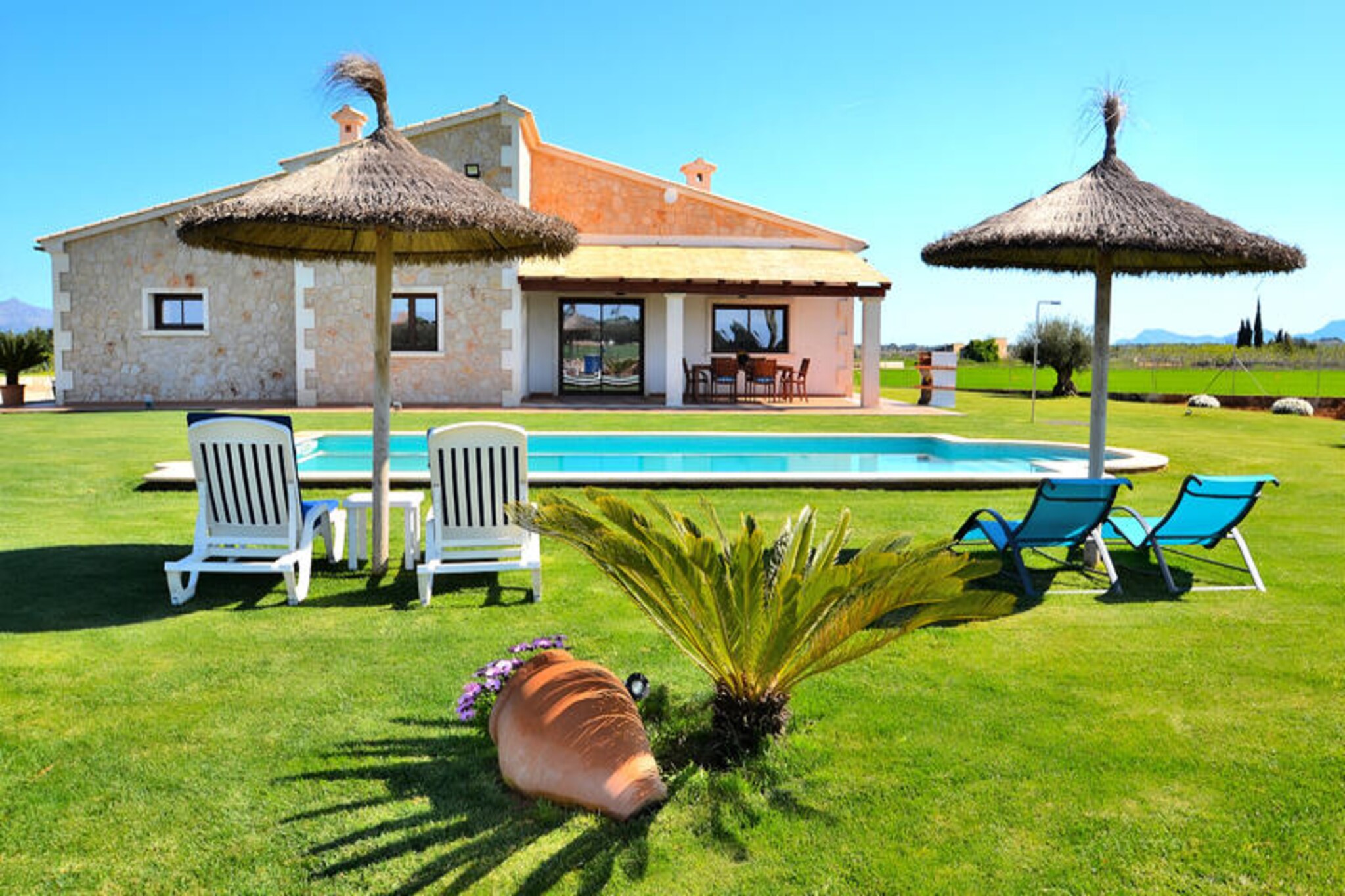 Amidst the serene countryside of Mallorca, this exquisite property near Muro offers a luxurious retreat for those seeking tranquility and Mediterranean charm. Surrounded by lush fields and just a short drive from the pristine beaches of Can Picafort and Platja de Muro, this villa combines the best of natural beauty and modern comfort. Whether you’re exploring the nearby S'Albufera Marine Protected Area or simply soaking up the sun by the pool, every moment here feels like a celebration of Mallorca’s timeless allure.\n\nDesigned to accommodate up to six guests, the villa boasts three elegant bedrooms—one with a double bed and two with twin beds—ensuring restful nights for all. The bathrooms are sleek and contemporary, while the fully equipped kitchen invites you to prepare delicious meals with ease. Adjacent to the kitchen, the spacious living-dining area is perfect for relaxing with family or friends, featuring a flat-screen TV, CD and DVD players for entertainment. Step outside to the covered terrace, where you can enjoy alfresco dining and barbecue evenings, all while taking in stunning views of the surrounding landscape. The private swimming pool, measuring 9x5 meters, offers a refreshing escape, complemented by sun loungers in the lush garden.\n\nLocated just minutes from Muro, a charming village steeped in Mallorcan tradition, the property provides easy access to cobbled streets, local markets, and authentic Mediterranean cuisine. For nature enthusiasts, the S'Albufera wetlands offer a haven of biodiversity, while beach lovers will revel in the soft sands and crystal-clear waters of nearby coastal gems. Whether you’re seeking adventure or relaxation, this villa places you at the heart of Mallorca’s treasures.\n\nEscape to this idyllic retreat and experience the perfect blend of luxury, nature, and culture. With its peaceful setting, modern amenities, and proximity to Mallorca’s finest attractions, this property promises an unforgettable holiday for families and friends alike.