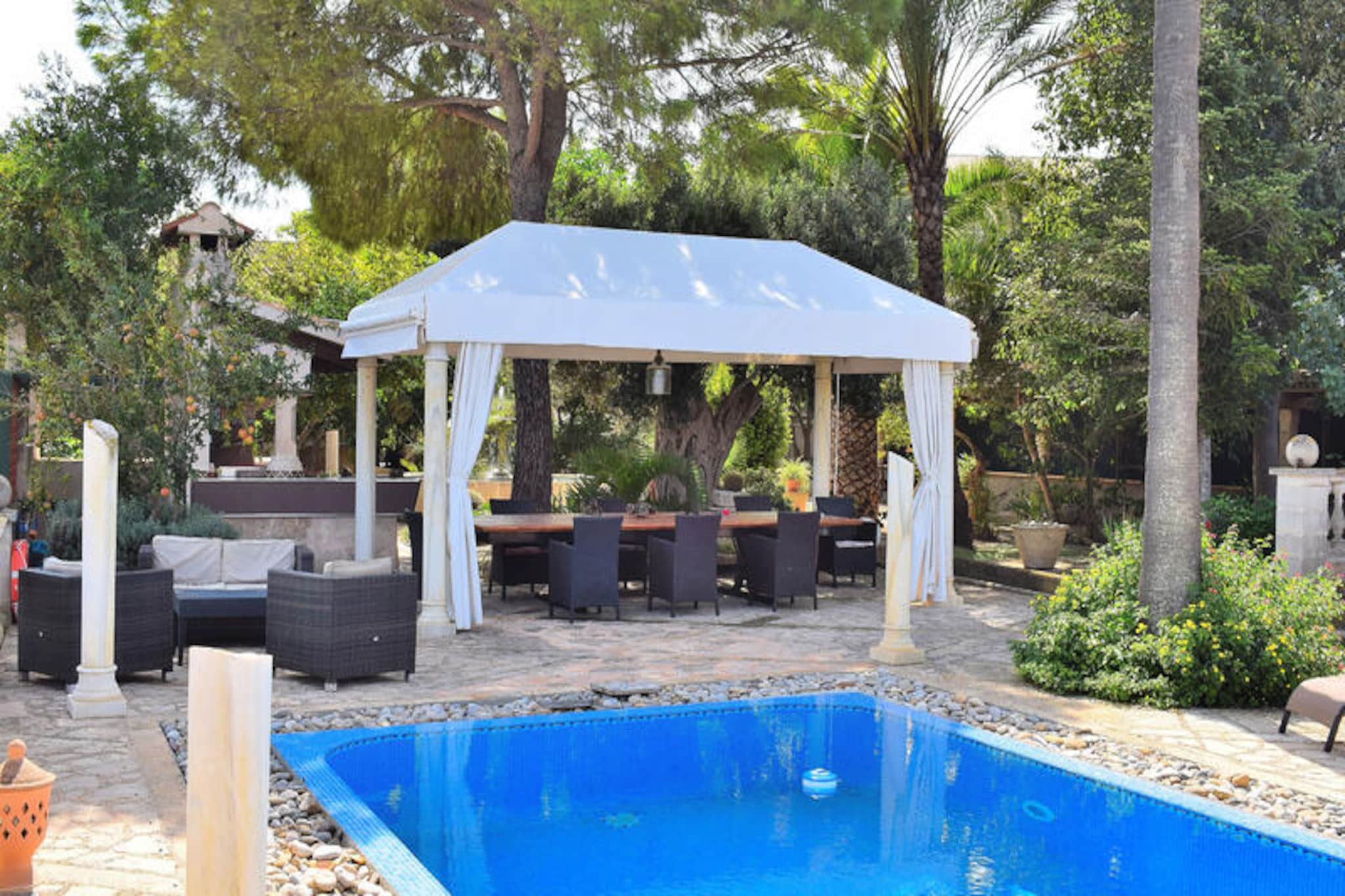 In the heart of Mallorca’s serene countryside, this enchanting village house in Muro invites you to experience the perfect Mediterranean escape. Surrounded by a lush 1,000 m² plot, this property offers a harmonious blend of traditional charm and modern comfort. With its proximity to the pristine beaches of Playa de Muro and the majestic Sierra de Tramuntana, it’s an ideal retreat for those seeking relaxation and adventure alike. \n\nStep inside this 400 m² home and be welcomed by an impressive reception hall that sets the tone for its elegant Majorcan style. The ground floor features a cozy living room with cable TV and a DVD player, a traditional kitchen equipped with modern appliances, and a bedroom with an adjacent bathroom. Upstairs, you’ll find three additional bedrooms and two bathrooms, one of which is en suite, all boasting freestanding bathtubs for a touch of luxury. The highlight of the house is the spacious conservatory, where you can dine, cook, and unwind while overlooking the inviting 4x8 meter swimming pool. \n\nThe outdoor area is a Mediterranean paradise, complete with a barbecue, a fountain, and vibrant plants and cacti. Enjoy fresh herbs from the garden as you prepare meals, or challenge friends and family to a game of ping-pong. Whether you’re lounging by the pool or exploring the cobblestone streets of Muro, this home offers an unforgettable holiday experience. \n\nDiscover the charm of Muro, a village steeped in tradition and surrounded by idyllic landscapes. With its authentic architecture, local markets, and proximity to both nature and the sea, it’s the perfect destination for those seeking the true essence of Mallorca.