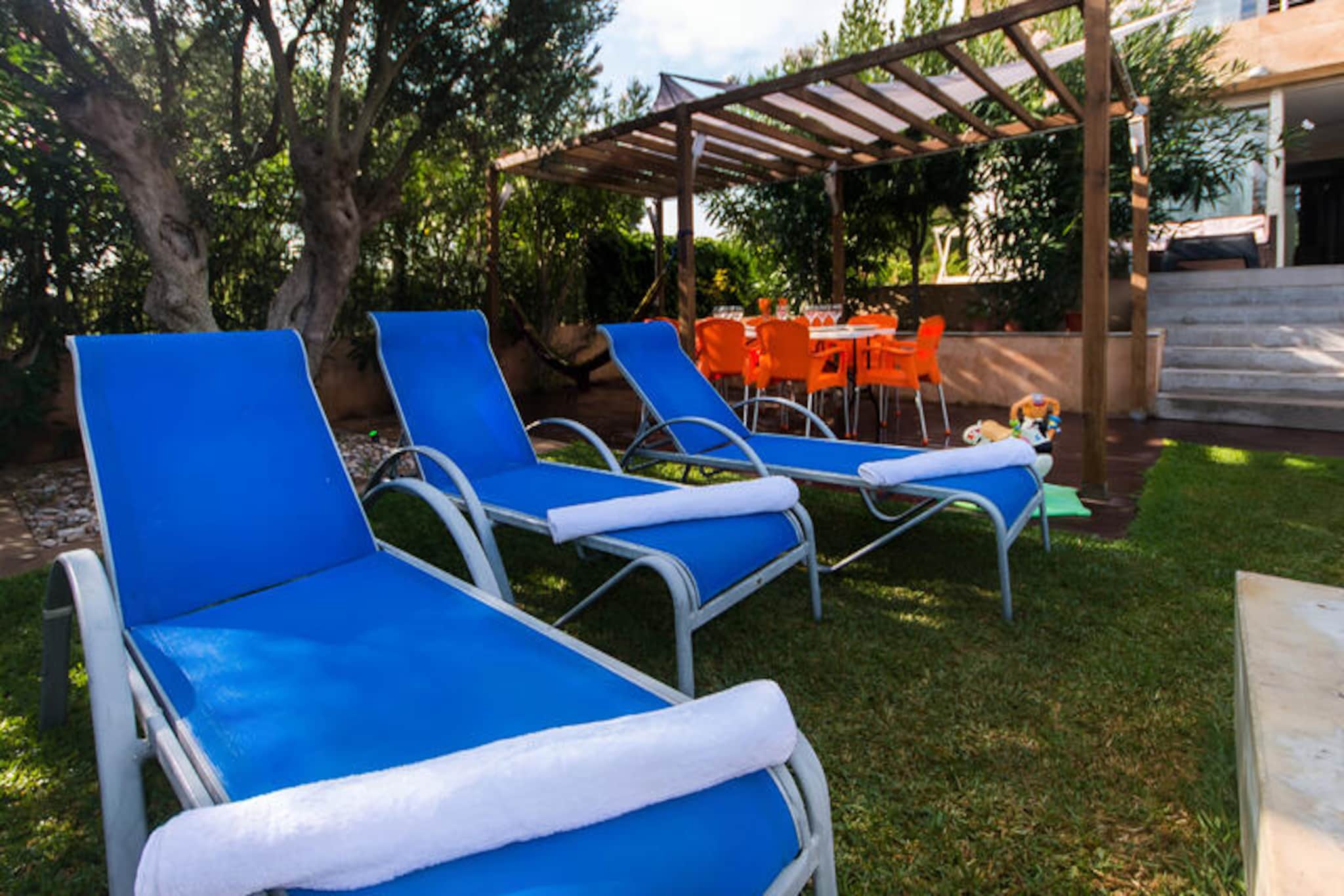 Just a stone's throw from the golden sands of Mallorca's northern coast, this modern villa offers the perfect retreat for families and friends seeking both relaxation and adventure. Located near the historic town of Alcúdia, known for its medieval charm and vibrant local culture, the villa is a haven for beach lovers and outdoor enthusiasts alike. With the beach just 100 meters away, you can wake up to the sound of waves and enjoy the crystal-clear waters renowned for kitesurfing and other water sports.
The villa comfortably accommodates up to eight guests, boasting a contemporary design that blends luxury with functionality. The spacious interiors include a bright living room with double-glazed doors opening onto terraces, a vibrant dining area, and a state-of-the-art kitchen equipped with everything you need for gourmet meals. The three twin bedrooms, each overlooking the lush gardens, share a stylish bathroom with a double walk-in shower. The master suite is a true highlight, featuring a private balcony with breathtaking views of the sea and the Sierra de Tramuntana mountains, a luxurious en-suite bathroom with a built-in bathtub, and a dressing room for added comfort.
Outside, the beautifully maintained gardens invite you to unwind. The fenced swimming pool, complete with a safety gate, ensures peace of mind for families with young children. Relax on the sun deck, dine al fresco under the shaded gazebo, or fire up the brick barbecue nestled beneath an ancient olive tree. Secure parking and thoughtful amenities make your stay seamless and stress-free.
Beyond the villa, the charming town of Alcúdia awaits with its cobbled streets, ancient walls, and bustling markets. Explore the island's rich history, indulge in local cuisine, or simply bask in the natural beauty of Mallorca. Whether you're here for the beach, the culture, or the tranquility, this villa offers an unforgettable Mediterranean escape.