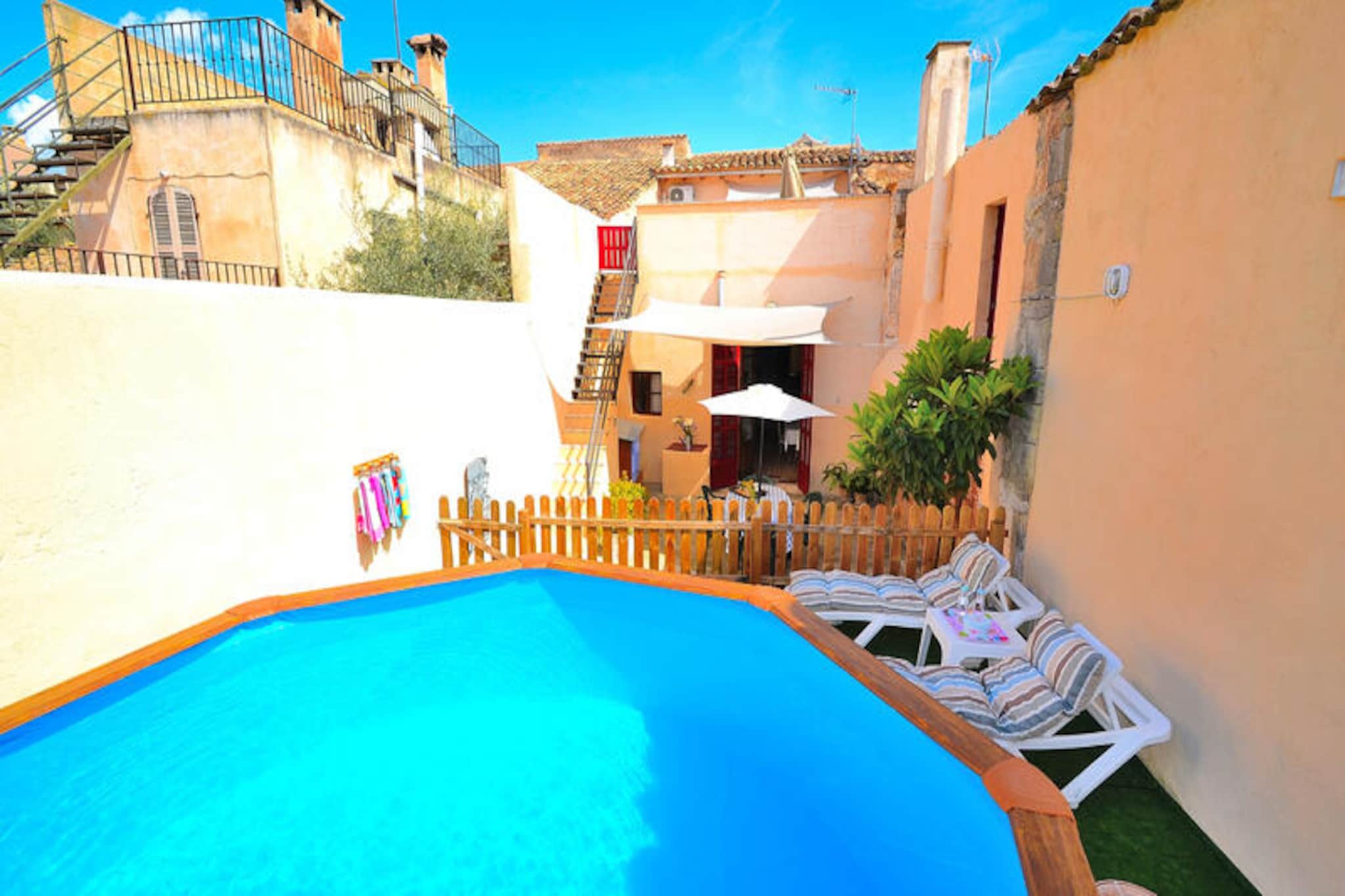 Step into the heart of Mallorca's timeless charm with this enchanting village house in Petra. Once a bustling bakery serving the local community, this historic home now offers a serene retreat far from the crowds, where the echoes of its past blend seamlessly with modern comforts. Imagine waking up to the soft Mediterranean light streaming through traditional wooden shutters, with the tranquil streets of Petra just outside your door. This is a place where history, culture, and relaxation come together in perfect harmony. \n\nThe house spans two floors and is thoughtfully designed to accommodate up to four guests. Upstairs, you’ll find two cozy bedrooms: one with a double bed and another with two single beds, both sharing a recently renovated bathroom with a walk-in shower. Downstairs, the spacious living room invites you to unwind with a good book or your favorite show on the TV, while the fully equipped kitchen, complete with a dining area and its own TV, is perfect for preparing delicious meals. Step outside to the charming inner courtyard, where a dining table awaits for al fresco meals. For ultimate relaxation, head to the rooftop terrace to enjoy breathtaking sunsets or take a refreshing dip in the private swimming pool. A barbecue area completes the outdoor space, making it ideal for long, leisurely evenings under the stars. \n\nPetra itself is a hidden gem, offering a glimpse into authentic Mallorcan life. Wander its cobbled streets, visit its historic landmarks, or simply soak in the peaceful atmosphere. The surrounding countryside is a haven for nature lovers, with picturesque landscapes and cycling trails waiting to be explored. Just a short drive away, you’ll find some of Mallorca’s most stunning beaches and cultural attractions, making this property the perfect base for your island adventures. \n\nWhether you’re seeking a quiet escape or a starting point for exploration, this unique village house in Petra promises an unforgettable stay filled with history, comfort, and the essence of Mallorca.