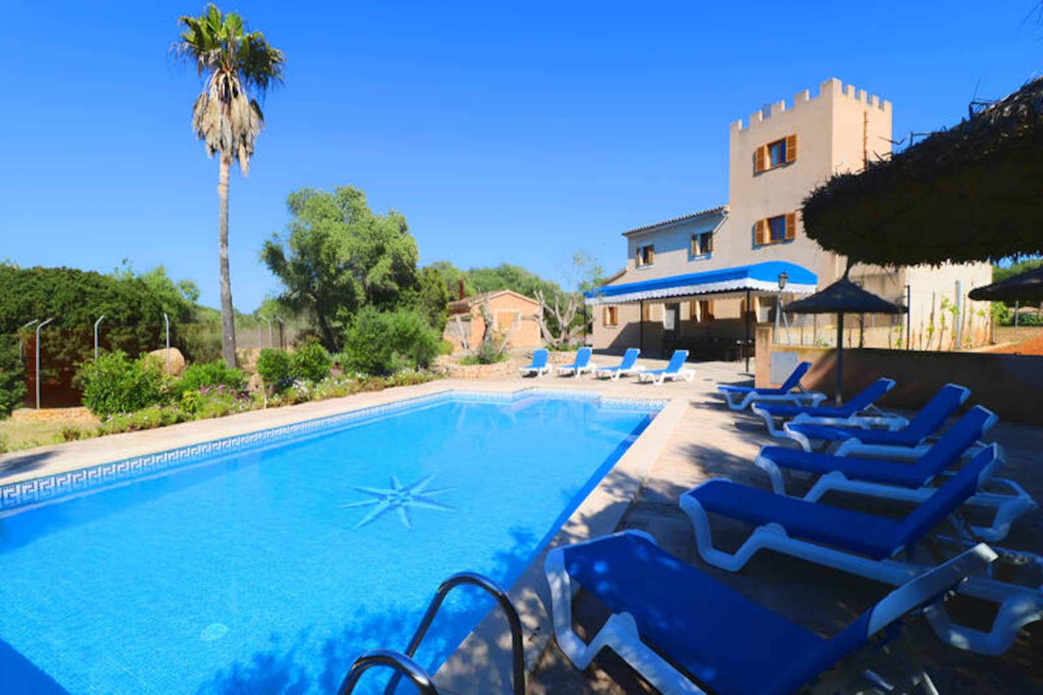 In the sun-drenched countryside of southern Mallorca, between the charming towns of Campos and Santanyí, this rustic manor-style retreat offers a perfect blend of tranquility and convenience. Surrounded by lush greenery and just a short drive from the island’s most stunning beaches—Es Trenc, Ses Covetes, Sa Rapita, and Sa Colònia—this property invites you to experience the authentic beauty of Mallorca. Whether you’re seeking a peaceful escape or an adventure-filled holiday, this home is the ideal base for exploring the island’s treasures. \n\nSpanning 257 m² across two floors and a picturesque tower, the house comfortably accommodates up to seven guests. Its rustic charm is complemented by modern amenities, including central heating, satellite TV, and Wi-Fi. The spacious living room with a cozy fireplace sets the tone for relaxed evenings, while the large dining room and semi-open kitchen, adorned with a beautiful archway, provide the perfect setting for shared meals. With five bedrooms—three featuring double beds and two with single beds—and three bathrooms, including an en suite, the layout ensures comfort and privacy for all. The tower bedroom, accessible via a spiral staircase, adds a unique touch to the property’s character. \n\nStep outside to discover a private oasis. The expansive 6x12m pool is perfect for refreshing swims, while the surrounding terraces and sun loungers invite you to bask in the Mediterranean sun. A covered outdoor area features a dining table for 16, a barbecue, and additional seating, making it ideal for al fresco dining and gatherings. \n\nWith its proximity to pristine beaches, vibrant towns, and local attractions, this property offers an unforgettable Mallorcan experience. Whether you’re exploring the historic streets of Campos, savoring local cuisine, or simply unwinding by the pool, this retreat promises a holiday filled with relaxation and discovery.