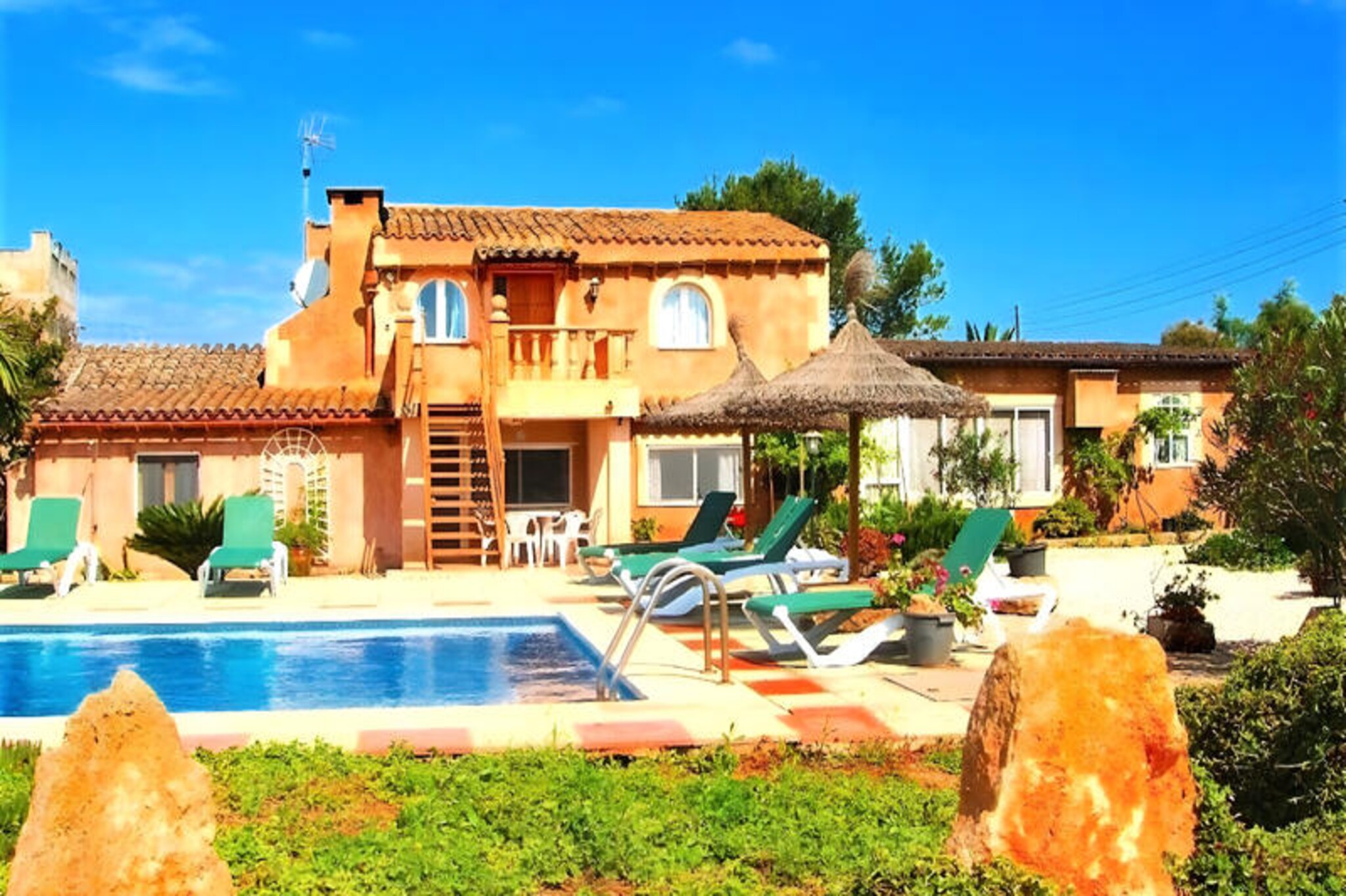 Amidst the serene countryside of southern Mallorca, this spacious and inviting farmhouse offers a tranquil retreat for families and friends. Surrounded by lush greenery and just a short drive from the island’s most stunning beaches, this property is the perfect blend of rustic charm and modern comfort. Whether you’re seeking relaxation or adventure, this idyllic setting promises an unforgettable holiday experience. \n\nWith 280 square meters of living space, this two-story farmhouse comfortably accommodates up to 8 guests. The interior exudes traditional Mallorcan charm with its rustic decor and warm ambiance. Two cozy living rooms—one on each floor—provide ample space to unwind, complete with sofas, armchairs, TVs, and Wi-Fi. The five bedrooms, including two with double beds and three with twin beds, ensure restful nights for everyone. Three bathrooms, two featuring bathtubs and one with a shower, add to the convenience. The fully equipped kitchen, with a large dining table seating 10, invites guests to share meals and create lasting memories together. \n\nStep outside to discover the beautifully maintained garden, a true highlight of this property. The 10x5m swimming pool offers a refreshing escape on warm summer days, while the barbecue area and outdoor dining spaces set the stage for delightful al fresco meals under the Mediterranean sky. This is a place where relaxation comes naturally, surrounded by the beauty of nature. \n\nLocated near the charming village of Campos, guests can explore its historic streets, savor local cuisine, and immerse themselves in Mallorcan culture. The property’s proximity to pristine beaches and vibrant local attractions makes it an ideal base for discovering the island. Whether you’re lounging by the pool, exploring nearby trails, or enjoying the local markets, this farmhouse offers a perfect blend of comfort and authenticity for your Mallorcan getaway.