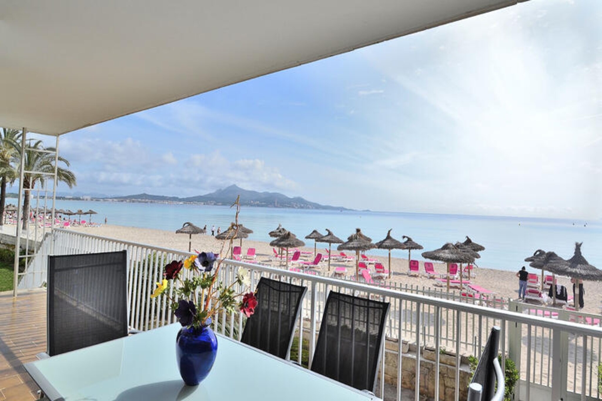 Awaken your senses to the serene allure of Alcudia Beach, where this exquisite first-floor apartment offers a front-row seat to Mallorca’s coastal splendor. From your private terrace and garden, gaze across the sweeping bay of Alcudia, a canvas of shimmering turquoise waters and golden sands. Each sunrise and sunset becomes a masterpiece, inviting you to relax on the provided sun loungers and soak in the Mediterranean charm. This is your sanctuary by the sea, where tranquility meets timeless beauty. \n\nSpanning 100 m², this classic apartment is thoughtfully designed to accommodate up to six guests. It features three air-conditioned bedrooms—two with double beds and one with twin singles—ensuring restful nights for all. Two bathrooms, one with a bathtub and another with a shower, complement an additional outdoor bathroom in the garden for added convenience. The living room is comfortably furnished, creating a cozy space to unwind, while the fully equipped kitchen, complete with a dishwasher and washing machine, makes meal preparation effortless. Every detail has been curated to enhance your stay, blending comfort with functionality. \n\nStep outside and discover the vibrant surroundings of Puerto de Alcúdia, a destination that seamlessly combines natural beauty with modern amenities. Stroll along the lively promenade, indulge in local cuisine, or dive into thrilling water sports. Nearby historical sites and entertainment options ensure there’s something for everyone, whether you’re seeking adventure or relaxation. This location offers the perfect balance of leisure and exploration. \n\nChoose this charming family holiday home for an unforgettable escape to Mallorca’s longest beach. With the soothing sound of the sea as your backdrop, every moment here is a celebration of island living. Let the magic of Alcudia Beach create memories that will last a lifetime.