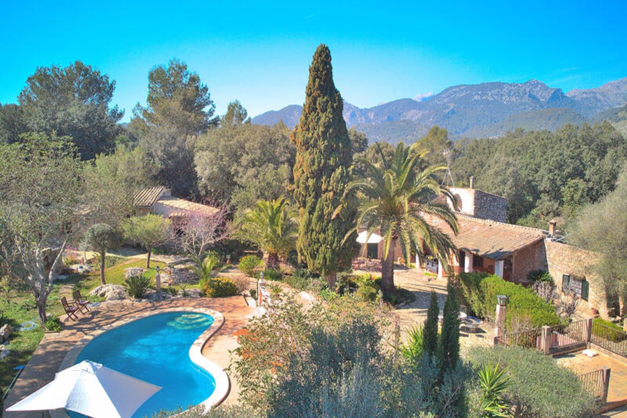 Amidst the serene countryside between Campanet and Pollensa, this enchanting Mallorcan villa invites you to experience the perfect harmony of tradition and modern comfort. Surrounded by lush landscapes and Mediterranean charm, this spacious retreat offers an idyllic escape for families and friends seeking tranquility and connection with nature. Imagine waking up to the gentle sound of birdsong, enjoying a morning coffee by the pool, and basking in the beauty of the island’s natural splendor. 
                      Spanning 280 m², the villa accommodates up to 10 guests with five thoughtfully designed bedrooms, including three double rooms and two twin rooms. The interior blends rustic elegance with modern amenities, featuring a cozy living-dining area complete with satellite TV, a DVD player, and WiFi. The fully equipped kitchen is perfect for preparing delicious Mediterranean meals, while the fireplace provides a warm ambiance for relaxing evenings. Air conditioning ensures comfort throughout the house, and three bathrooms, including one with a corner bathtub, cater to your needs. 
                      The outdoor space is a true highlight, with an expansive 11,500 m² property offering a 9x4 m swimming pool surrounded by comfortable sun loungers. Multiple seating areas invite you to unwind and soak in the peaceful surroundings, while the outdoor kitchen and barbecue set the stage for delightful al fresco dining. Whether you’re swimming, sunbathing, or enjoying a barbecue under the stars, the villa’s outdoor area promises unforgettable moments. 
                      Located near the picturesque village of Pollensa, you’ll have easy access to cobbled streets, vibrant markets, and cultural treasures. Explore nearby beaches, hike the surrounding mountains, or simply revel in the timeless beauty of Mallorca. This villa is your gateway to an authentic island experience, offering privacy, comfort, and the magic of Mediterranean living.