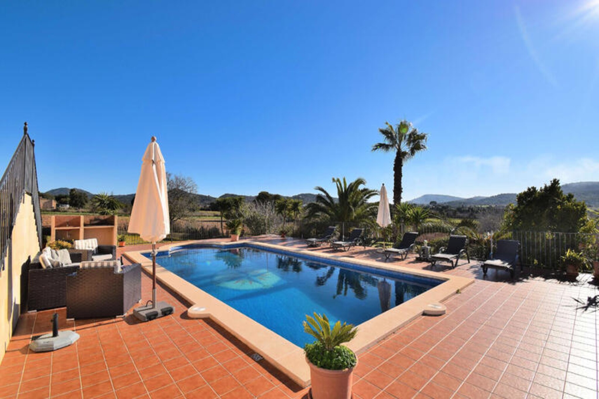 Step into the heart of Mallorca’s countryside and discover this enchanting farmhouse in Cas Concos, where rustic charm meets modern comfort. Surrounded by vineyards and rolling hills, this property offers a serene escape for families and groups seeking tranquility and authentic island living. Wake up to the gentle sounds of nature and enjoy breathtaking views from the terraces on both floors, each capturing the beauty of southern Mallorca’s landscape. Whether you’re exploring the nearby village or relaxing by the pool, this farmhouse invites you to experience the essence of Mediterranean life. \n\nInside, the property boasts a spacious and welcoming layout. The ground floor features a large entrance hall, a cozy living/dining room, and a fully equipped kitchen that’s perfect for preparing meals with local ingredients. A twin bedroom and a bathroom with a shower complete this level. Upstairs, you’ll find three additional bedrooms—two with double beds and one with twin beds—alongside two bathrooms with bathtubs. With air conditioning throughout, every corner of the house is designed for comfort and relaxation. \n\nStep outside to discover the true highlight of this property: its expansive outdoor spaces. The lush garden and barbecue area set the stage for memorable meals under the stars, while the large swimming pool and sun loungers provide the perfect spot to unwind. Whether you’re soaking up the sun or enjoying a refreshing dip, the outdoor areas promise endless moments of leisure and joy. \n\nLocated just a 20-minute drive from some of Mallorca’s most stunning beaches, and within walking distance of Cas Concos village, this farmhouse is ideally situated for exploring the island’s natural beauty and cultural treasures. From cobbled streets and local markets to scenic trails and coastal adventures, every day brings new opportunities to create unforgettable memories. Make this charming retreat your home away from home and embrace the magic of Mallorca.