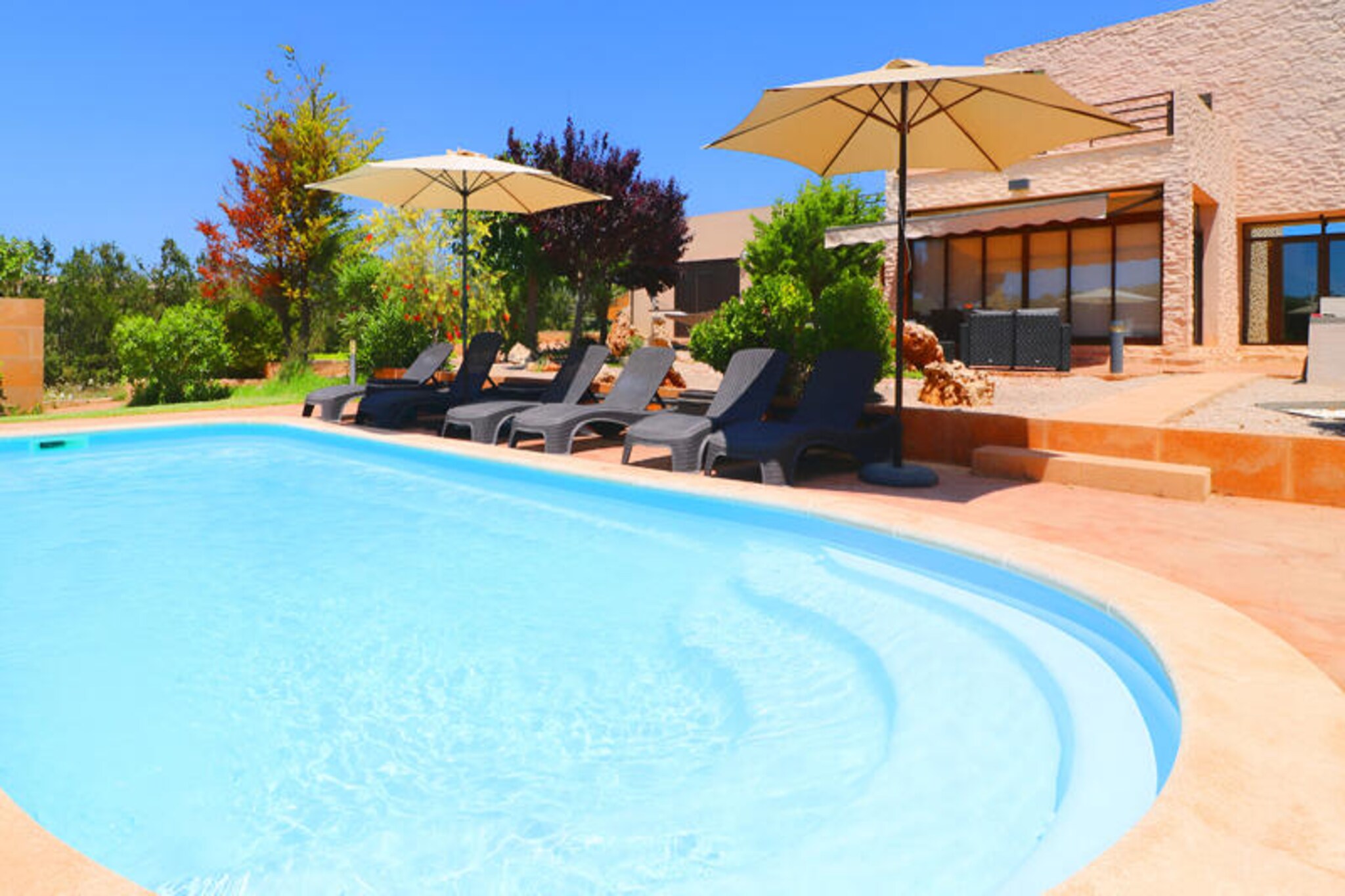 Amidst the tranquil countryside of Mallorca, Villa Son Vigili invites you to experience the perfect blend of modern comfort and rural charm. Located near the picturesque village of Campos, this stunning retreat offers a serene escape surrounded by green fields and close to some of the island’s most spectacular beaches, including the pristine Es Trenc and Sa Rápita. Whether you’re seeking relaxation or adventure, this villa provides an idyllic setting for your holiday. Campos itself, with its vibrant weekly markets and authentic Mallorcan atmosphere, is just a short drive away, offering a taste of local culture and cuisine. \n\nStep inside this recently built villa and discover a bright, contemporary space designed for comfort and style. Large windows flood the interiors with natural light, while central heating, air conditioning in all three bedrooms, and a ceiling fan in the living room ensure year-round comfort. The open-plan kitchen, complete with an island, breakfast bar, and dining table, is fully equipped for all your culinary needs. The spacious living/dining area features a cozy sofa, TV, CD/DVD player, and Wi-Fi, making it the perfect spot to unwind. The villa boasts three beautifully appointed bedrooms, including a master suite with an en-suite bathroom and jacuzzi, as well as two additional bathrooms with showers. \n\nOutside, the villa’s private grounds are a haven of relaxation and fun. Lounge by the pool in the hammock area, fire up the barbecue for al fresco dining, or let the children enjoy the dedicated play area. The villa’s location also makes it easy to explore the natural beauty of Mallorca, from its golden beaches to its charming villages. \n\nVilla Son Vigili is more than just a holiday home; it’s a gateway to the authentic Mallorcan experience. Whether you’re strolling through Campos’ historic streets, savoring local delicacies, or soaking up the sun by the pool, every moment here promises unforgettable memories. Book your stay now and discover the magic of Mallorca from this exceptional retreat.
