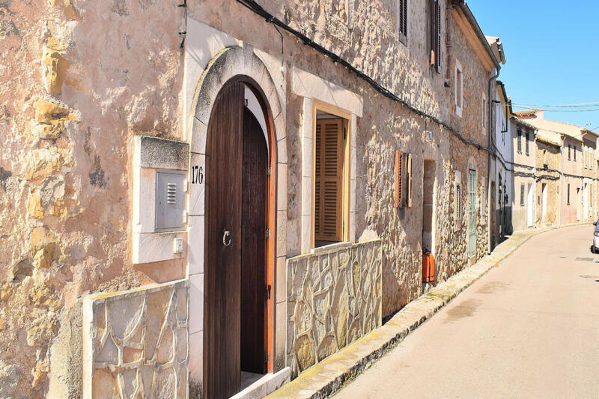 In the heart of Mallorca's serene countryside, this charming village house in María de la Salut invites you to experience the island's authentic essence. Surrounded by rolling green fields and just a short drive from the pristine white sands of Can Picafort and Alcúdia, this tranquil retreat offers the perfect blend of rural charm and modern comfort. Wander through the picturesque streets of María de la Salut, where traditional architecture and a warm local culture create a truly unique atmosphere. \n\nThe house is thoughtfully designed for relaxation and connection. On the ground floor, you'll find a cozy bedroom next to a bathroom, a semi-open kitchen leading to a welcoming living room with two comfortable sofas, Wi-Fi, and satellite TV. Upstairs, two additional bedrooms, a bathroom, and a balcony open up to a terrace with stunning mountain views. Outside, the private terrace area is perfect for unwinding, complete with hammocks, a barbecue, and a peaceful ambiance that invites you to savor every moment. \n\nMaría de la Salut is ideally located for exploring Mallorca's treasures. Just 15 km from the northern beaches and close to the vibrant village of Sineu, known for its weekly market and culinary delights, you'll have the best of the island within easy reach. Whether you're seeking a quiet escape or an adventure-filled holiday, this village house offers a perfect base to create unforgettable memories. \n\nDiscover the soul of Mallorca in this hidden gem, where the pace of life slows down, and every day feels like a celebration of nature and tradition.