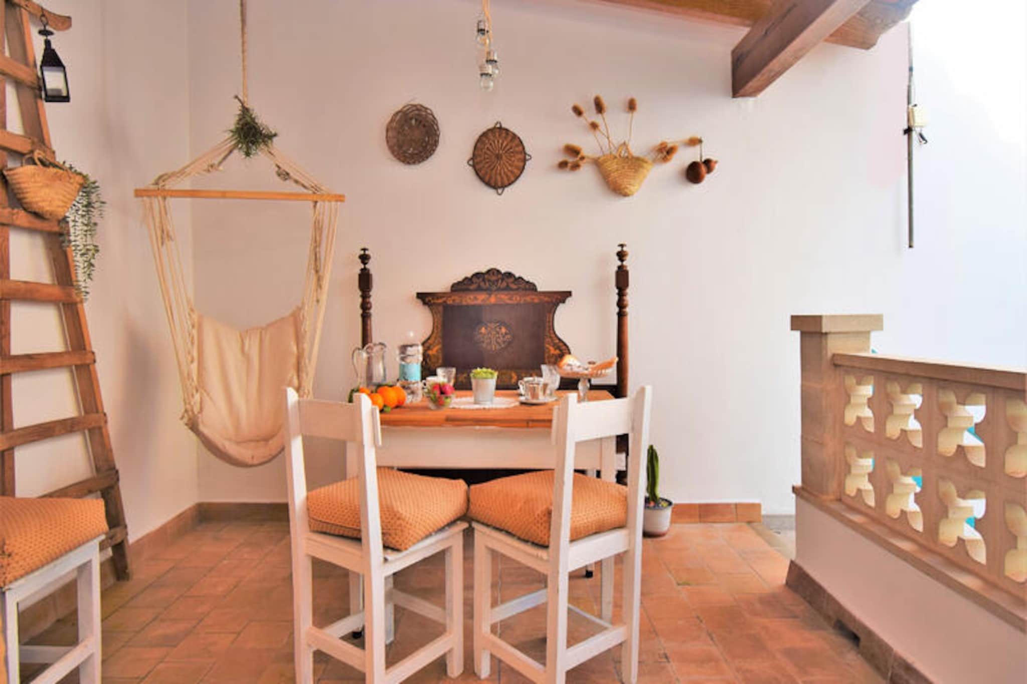 In the heart of the picturesque village of Muro, this charming townhouse invites you to experience the authentic essence of Mallorca. Surrounded by rolling countryside and just a short drive from the island’s most stunning beaches, this home offers a perfect balance of tranquility and convenience. Stroll through Muro’s cobbled streets, admire its traditional architecture, and soak in the warm Mediterranean atmosphere that makes this destination so unique. \n\nThis beautifully maintained townhouse is designed for comfort and relaxation, accommodating up to five guests across two floors. The ground floor features a cozy living and dining area, a fully equipped kitchen where you can prepare your favorite meals, and a bathroom with a shower. Step outside to the welcoming courtyard, a perfect spot to unwind with a book or a refreshing drink. The courtyard connects to a first-floor terrace complete with a barbecue area, ideal for enjoying long, leisurely evenings under the stars. Upstairs, you’ll find three bedrooms—two with twin beds and one with a single bed—along with another bathroom with a shower. Modern amenities such as air conditioning in the living room and hallway ensure a comfortable stay year-round. \n\nMuro’s prime location allows you to explore the best of Mallorca with ease. Discover nearby pristine beaches, indulge in local culinary delights, or venture into the surrounding countryside for hiking and cycling adventures. Whether you’re seeking a peaceful retreat or a base to explore the island, this townhouse offers the perfect setting for an unforgettable holiday. Let the charm of Muro and the comfort of this home create memories you’ll cherish forever.