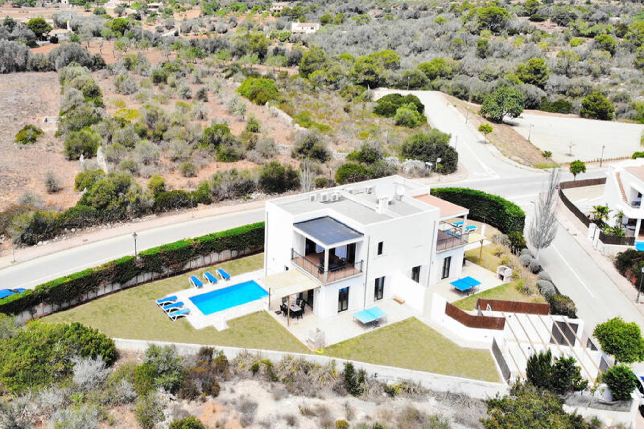 In the heart of Mallorca’s southeastern coast, this modern villa invites you to experience the charm of Cala d’Or, a destination known for its stunning beaches and sophisticated ambiance. Surrounded by Mediterranean beauty, the villa is part of a new development near the prestigious Cala d’Or Yacht Club and marina, offering a perfect blend of tranquility and elegance. Whether you’re seeking relaxation or adventure, this villa serves as your gateway to the island’s treasures. \n\nDesigned for comfort and entertainment, the villa boasts air-conditioned interiors, Wi-Fi, and a sound system. The spacious master bedroom features a private balcony with views of the treetops and countryside, while the ground-floor bedrooms open directly onto the sunny pool terrace. Here, you’ll find a sparkling swimming pool, a lush lawn, a barbecue area, and ample outdoor furniture for al fresco dining or lounging. A ping-pong table on the terrace adds a playful touch for family fun. Groups of families or friends can enjoy the proximity to Villa Baltasar, making it ideal for shared holidays. \n\nCala d’Or itself is a glamorous seaside resort with an elegant harbor, secluded coves, and luxury boutiques. The area offers seven pristine beaches with fine sand and crystal-clear waters, perfect for swimming or sunbathing. The center of Cala d’Or is just a 15-minute walk away, while Cala Gran beach is a 25-minute stroll. Golf enthusiasts will appreciate the nearby Val d’Or Golf course, only a 10-minute drive, and the charming coastal town of Porto Petro is just 4 minutes away by car. \n\nWhether you’re drawn to the vibrant atmosphere, the serene beaches, or the Mediterranean lifestyle, this villa provides the perfect base for an unforgettable Mallorcan escape. Discover the magic of Cala d’Or and create lasting memories in this idyllic setting.