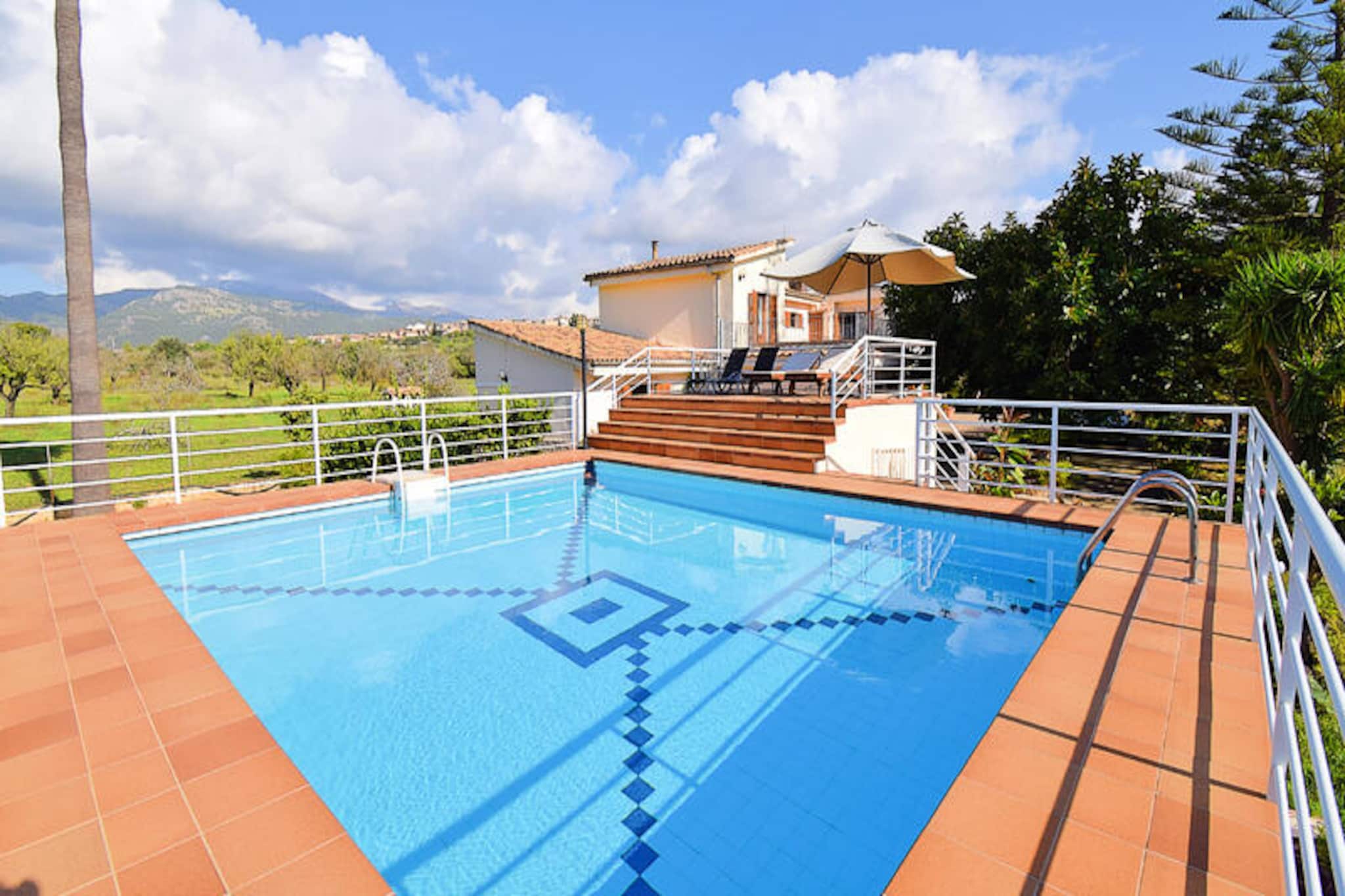 In the heart of Mallorca’s countryside, this charming farmhouse near the peaceful village of Campanet invites you to experience the authentic essence of the island. Surrounded by rolling hills and picturesque landscapes, this holiday home offers a serene retreat far from the bustle of mass tourism. Wake up to the gentle sounds of nature and enjoy breathtaking views that stretch across the horizon, creating a perfect setting for relaxation and rejuvenation. Located just 18 kilometers from the golden sands of Playa de Muro, you can easily combine tranquil days with beachside adventures. \n\nThe spacious 185 m² home is thoughtfully designed to accommodate up to six guests. Spread across two floors, it features four air-conditioned bedrooms—two with double beds, one with twin beds, and one single room—ensuring comfort for families or groups. The living room, with its cozy sofa and satellite TV, is perfect for unwinding, while the fully equipped kitchen makes meal preparation a delight. Modern amenities such as Wi-Fi, a washing machine, dryer, and ironing station ensure a seamless stay. Two bathrooms, one with a bathtub and the other with a shower, provide convenience for all guests. \n\nStep outside to the covered terrace, where you can savor meals or simply relax in the fresh air. A barbecue area adds a touch of fun to your evenings, while the private swimming pool offers a refreshing escape on warm summer days. Comfortable sun loungers invite you to soak up the Mediterranean sun, making every moment outdoors a pleasure. \n\nCampanet itself is a treasure trove of Mallorcan charm, with its traditional architecture, welcoming squares, and local cuisine. Nearby attractions include the famous caves and scenic trails, perfect for exploring the island’s natural beauty. Whether you’re seeking tranquility or adventure, this farmhouse is your gateway to an unforgettable Mallorcan experience.