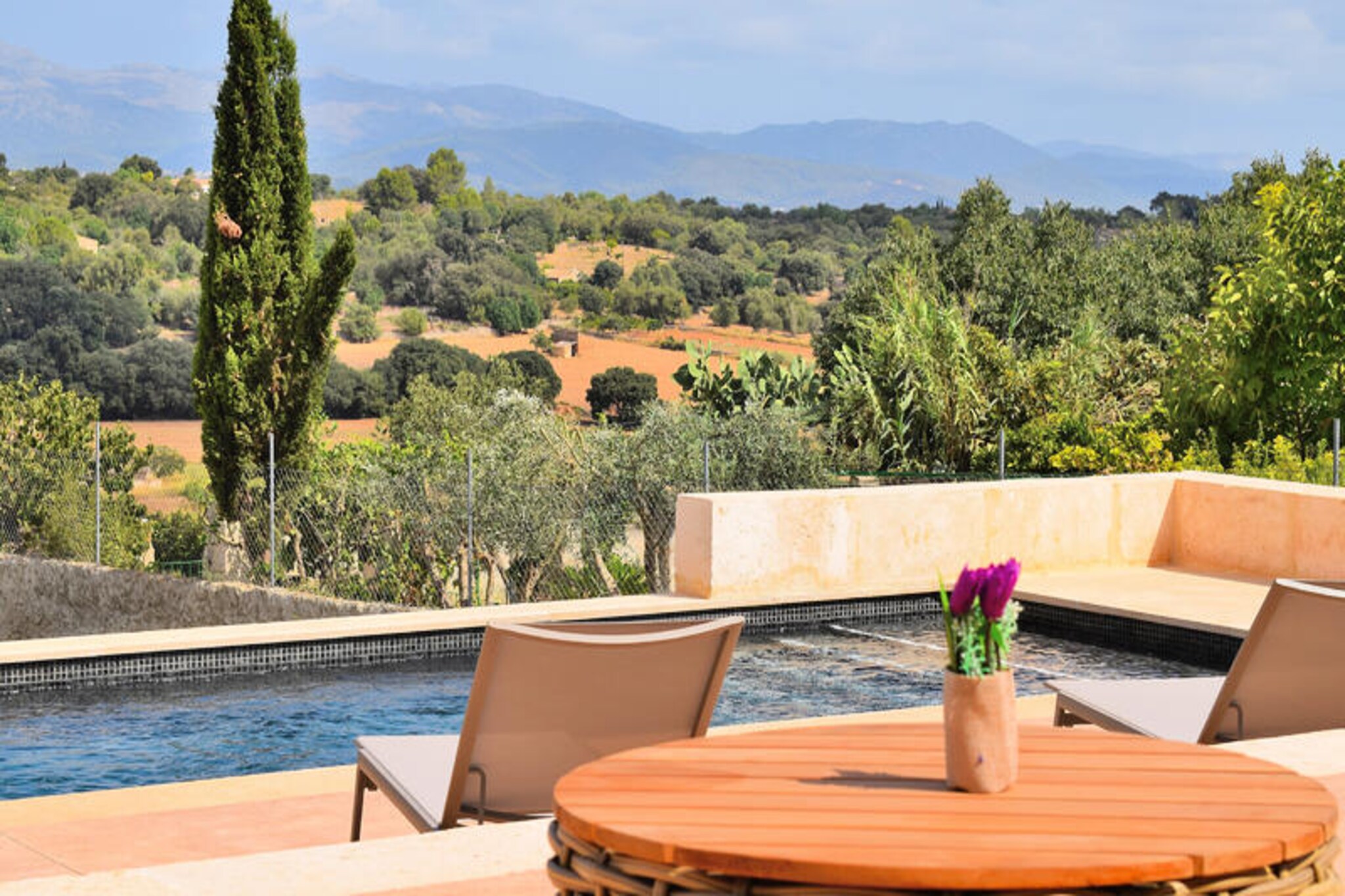 In the heart of the picturesque village of Llubá, this inviting house offers a serene retreat for those seeking the authentic charm of Mallorca. Surrounded by the tranquil beauty of the island’s countryside, the property provides a perfect blend of traditional architecture and modern comfort, making it an ideal choice for families or groups of up to ten guests. Here, you can immerse yourself in the peaceful rhythm of village life while being just a short drive from Mallorca’s stunning beaches and vibrant attractions.
The house boasts six spacious bedrooms, three bathrooms with showers, and an additional toilet, ensuring ample space and privacy for all guests. The fully equipped kitchen invites you to prepare delicious meals with fresh local ingredients, while the expansive outdoor area is the true highlight of this property. Relax under the Mediterranean sun on comfortable hammocks, gather around the large table for al fresco dining, or unwind in the cozy seating area surrounded by lush greenery. The property’s thoughtful amenities and welcoming ambiance make it a haven for relaxation and connection.
Llubá is a hidden gem in Mallorca, offering visitors a glimpse into the island’s rich culture and traditions. Stroll through its charming squares, discover local markets, and enjoy the warm hospitality of the community. Nature enthusiasts will appreciate the proximity to scenic hiking trails and the pristine beaches of the northern coast, while history lovers can explore nearby landmarks and ancient sites.
Whether you’re seeking a peaceful escape or an adventure-filled holiday, this property in Llubá promises an unforgettable experience. Let the beauty of Mallorca and the comfort of this house create lasting memories for you and your loved ones.