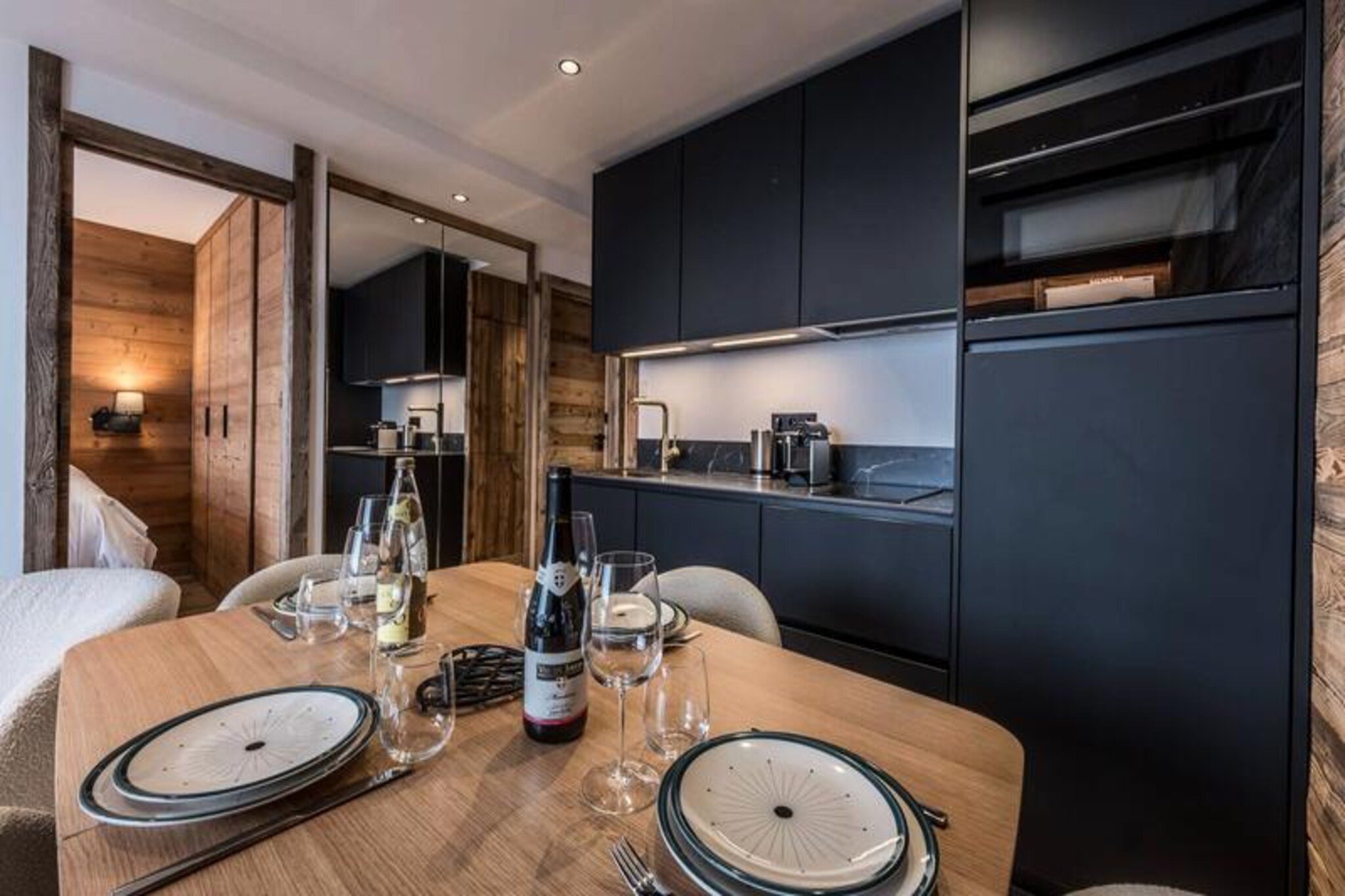 High above the world, where the snow-capped peaks of Courchevel 1850 meet the vibrant energy of the resort, this meticulously renovated apartment offers an unparalleled alpine escape. Imagine waking up to the crisp mountain air and stepping onto your private balcony to take in panoramic views of the majestic slopes and the lively village below. This is more than just a stay; it’s an invitation to experience the magic of the French Alps in absolute comfort and style.
Inside, the 38 m² apartment is a masterclass in modern mountain living. The cozy living room, complete with a dining area, plush sofa, and television, is the perfect spot to unwind after a day on the slopes. The fully equipped open-plan kitchen, featuring a combination microwave oven, Magimix coffee machine, and dishwasher, ensures that every meal is a pleasure to prepare. The sleeping arrangements are thoughtfully designed, with a serene double bedroom offering ample storage and a safe, and a charming cabin bedroom with a bunk bed, USB ports, and a bedside lamp, ideal for children or additional guests. A sleek bathroom with a bathtub and a separate toilet complete the layout, ensuring convenience for all.
Step outside, and you’re immediately on the slopes, thanks to the ski-in/ski-out access. The residence’s central location places you just moments away from Courchevel’s finest dining, shopping, and après-ski spots. Whether you’re carving through fresh powder or exploring the vibrant resort center, every moment here is infused with the spirit of adventure.
With added luxuries like fiber optic internet, a ski locker, and a covered parking space, as well as thoughtful touches such as beds made upon arrival and end-of-stay cleaning, this apartment is designed to make your stay effortless and memorable. Choose this alpine retreat for an unforgettable journey into the heart of the Three Valleys.