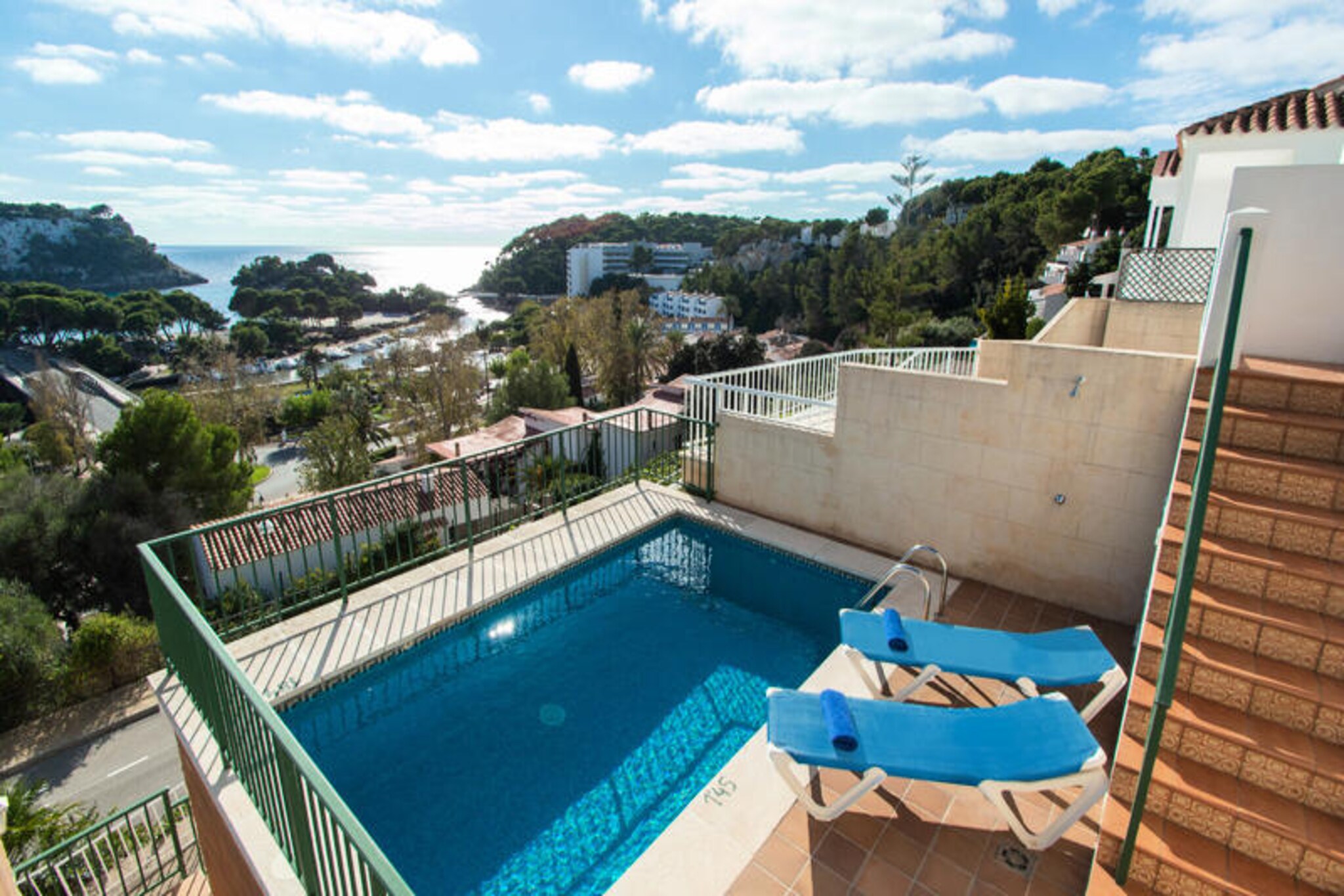 Perched above the sparkling waters of Cala Galdana, Lluís House offers a serene Mediterranean escape on the stunning island of Menorca. Imagine waking up to the gentle sound of waves and stepping out onto your private balcony to take in panoramic views of the turquoise sea and lush cliffs. This charming duplex apartment is the perfect retreat for families or small groups seeking both comfort and a touch of island magic. 
 
 The property boasts two spacious double bedrooms on the upper floor, one with a double bed and the other with two single beds, each opening onto a private balcony with breathtaking sea views. A family bathroom with a bathtub and hairdryer completes the upstairs amenities. Downstairs, the living and dining area is a cozy space with two comfortable sofas, a television, and a dining table for shared meals. The fully equipped kitchen includes everything you need, from a stovetop and oven to a microwave and kettle, making it easy to prepare delicious meals. 
 
 Step outside to discover your private oasis. The outdoor area features a sparkling swimming pool surrounded by sun loungers, perfect for soaking up the Mediterranean sun. A barbecue and additional balcony provide the ideal setting for al fresco dining with views of Cala Galdana. Modern conveniences such as air conditioning and Wi-Fi ensure a relaxing and hassle-free stay. 
 
 Located next to its twin property, David House, Lluís House is ideal for two families or groups traveling together, offering proximity while maintaining privacy. With live music from the nearby Cala Galdana Hotel adding to the vibrant atmosphere during peak season, and the pristine beaches and natural beauty of Menorca at your doorstep, this is a destination that promises unforgettable memories.