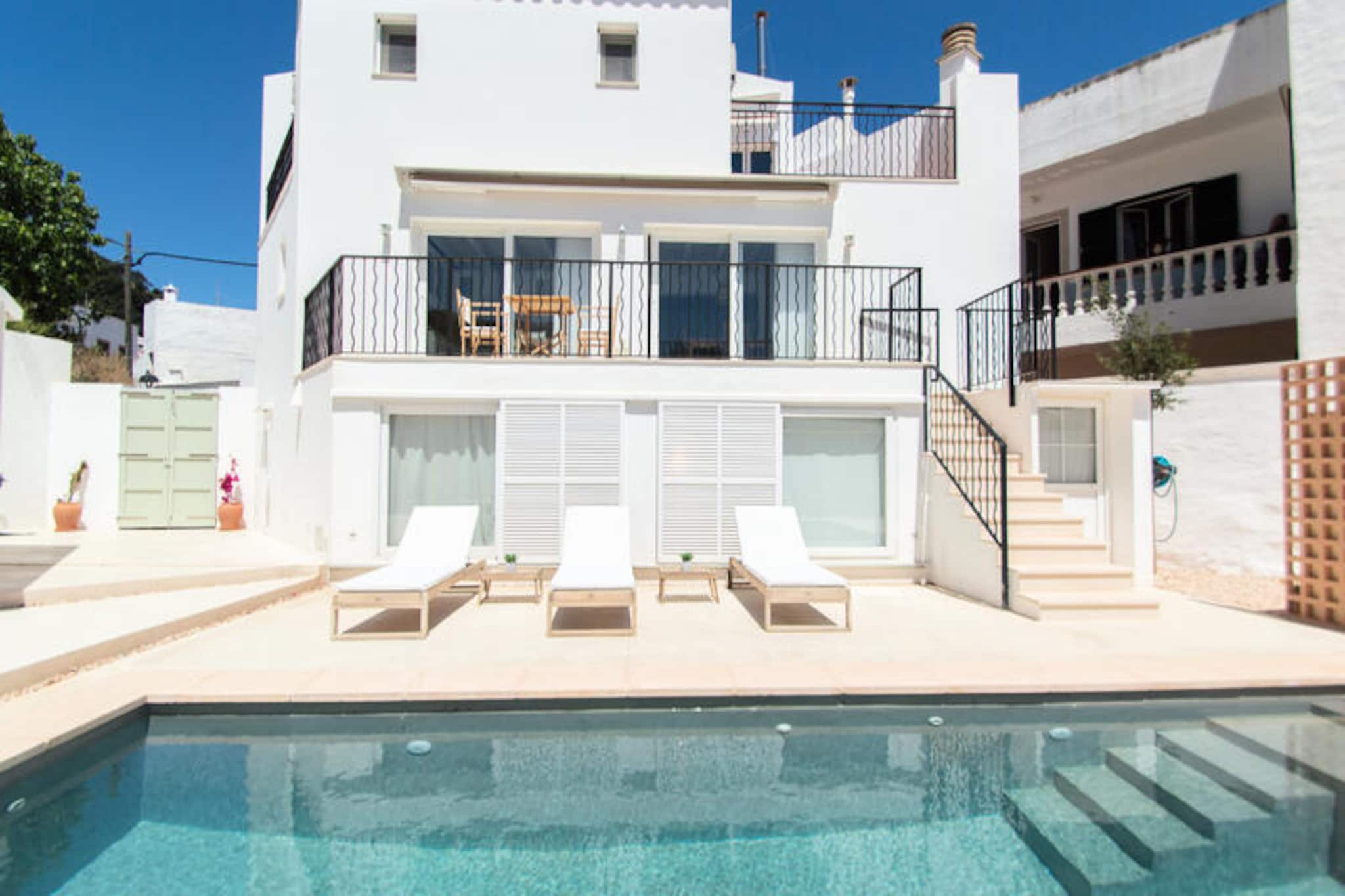 In the heart of Ferreries, where the charm of Menorca’s countryside meets the convenience of urban life, this stunning villa offers a perfect retreat for families or groups of up to eight. Surrounded by lush greenery and with breathtaking views of the mountains and your private swimming pool, this home invites you to unwind and savor the Mediterranean lifestyle. Whether you’re seeking relaxation or adventure, this property provides the ideal setting for an unforgettable holiday. \n\nSpanning 160 m², the villa is tastefully designed with modern furnishings and thoughtful touches that ensure both comfort and style. With four spacious bedrooms, a fully equipped kitchen featuring everything from a dishwasher to a juicer, and a cozy living area with satellite TV and Wi-Fi, every detail has been considered. The outdoor space is equally inviting, with a private pool, a lush garden, and a terrace complete with garden furniture and a barbecue, perfect for al fresco dining under the stars. Additional amenities such as air conditioning, a fireplace, and a washing machine make your stay as convenient as it is luxurious. \n\nLocated in the vibrant town center of Ferreries, the villa is just steps away from local restaurants, supermarkets, and a bus station, making it easy to explore the island. The stunning sandy beaches of Cala Galdana and Cala Mitjana are only a short drive away, offering crystal-clear waters and golden sands. For golf enthusiasts, the Son Parc Golf Course is just 25 km away, while nature lovers can enjoy the rugged beauty of Ets Alocs beach. With Mahón Airport only 35 km away, getting here is a breeze. \n\nWhether you’re lounging by the pool, exploring Menorca’s pristine beaches, or enjoying a meal at a nearby restaurant, this villa is your gateway to the best of the island. Create lasting memories in this serene and stylish haven, where every moment feels like a dream come true.