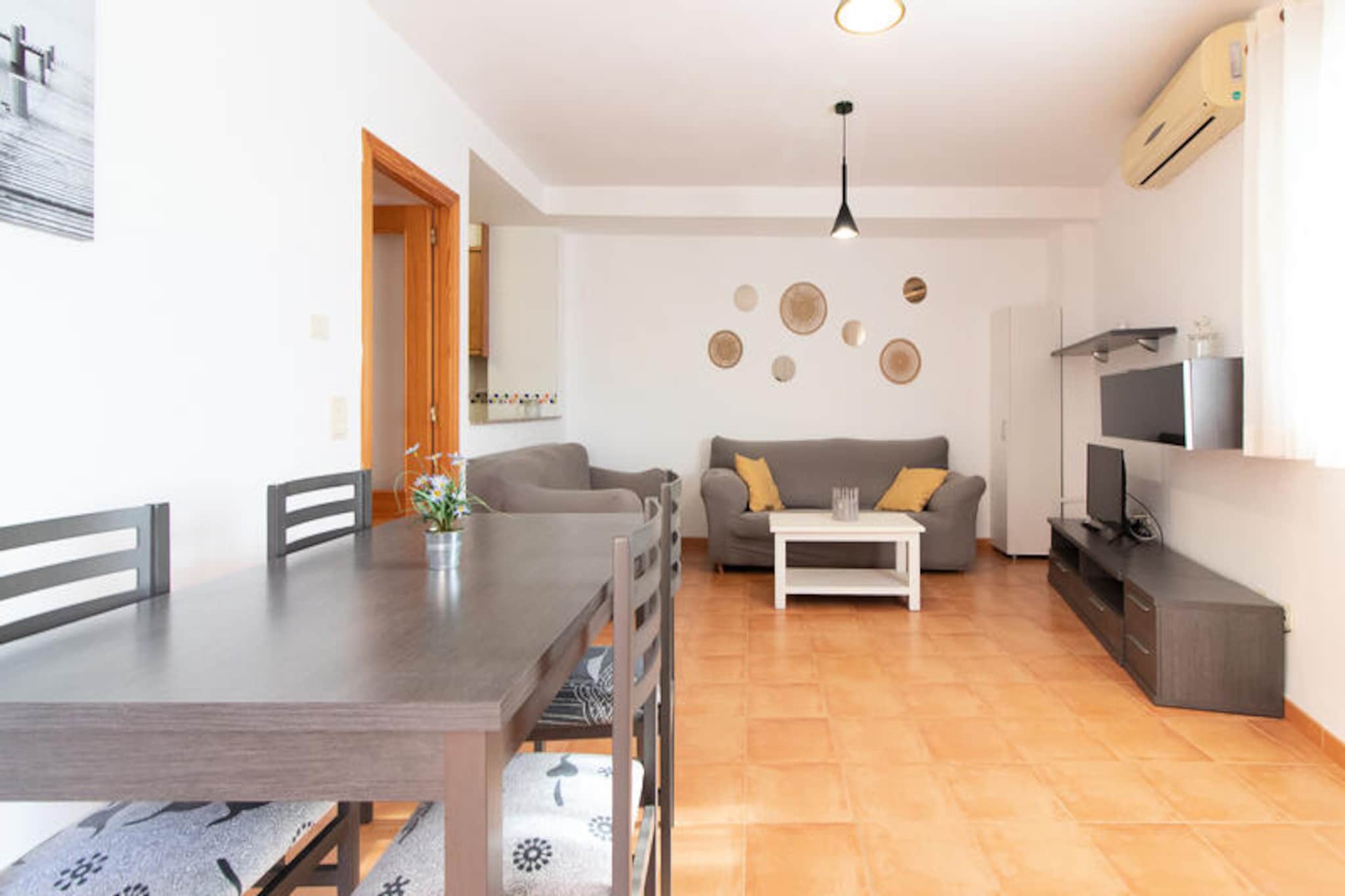 In the charming coastal town of Canet d'en Berenguer, this delightful apartment offers a serene escape just moments from the Mediterranean Sea. With its sunlit interiors and modern amenities, this property is perfect for couples or small families seeking a relaxing getaway in Spain's Valencia region. Imagine waking up to the gentle sea breeze, enjoying breakfast on your private terrace, and spending your days exploring golden beaches or lounging by the shared swimming pool. Here, every moment feels like a retreat from the everyday. 
 
 The apartment spans 79 m² and is thoughtfully designed for comfort and convenience. It features two cozy bedrooms, a bright living room with air conditioning, and a fully equipped kitchen with all the essentials, including a ceramic hob, refrigerator, microwave, and coffee maker. Additional amenities such as Wi-Fi, a washing machine, mosquito nets, and a TV ensure a hassle-free stay. The spacious 14 m² terrace, complete with garden furniture, invites you to unwind with a good book or savor a glass of local wine as the sun sets. On-site outdoor parking and a heat pump for heating add to the apartment's practicality. 
 
 Canet d'en Berenguer is renowned for its pristine beaches, vibrant local markets, and charming seaside promenade. Nearby, you'll find a variety of restaurants serving fresh seafood and traditional Valencian dishes. For those seeking adventure, the historic city of Valencia is just a short drive away, offering cultural landmarks, bustling plazas, and the famous City of Arts and Sciences. Whether you're here to relax or explore, this apartment provides the perfect base for your Mediterranean holiday. 
 
 Book your stay today and experience the beauty and tranquility of Spain's eastern coast. With its ideal location and welcoming ambiance, this apartment promises a memorable vacation for all.