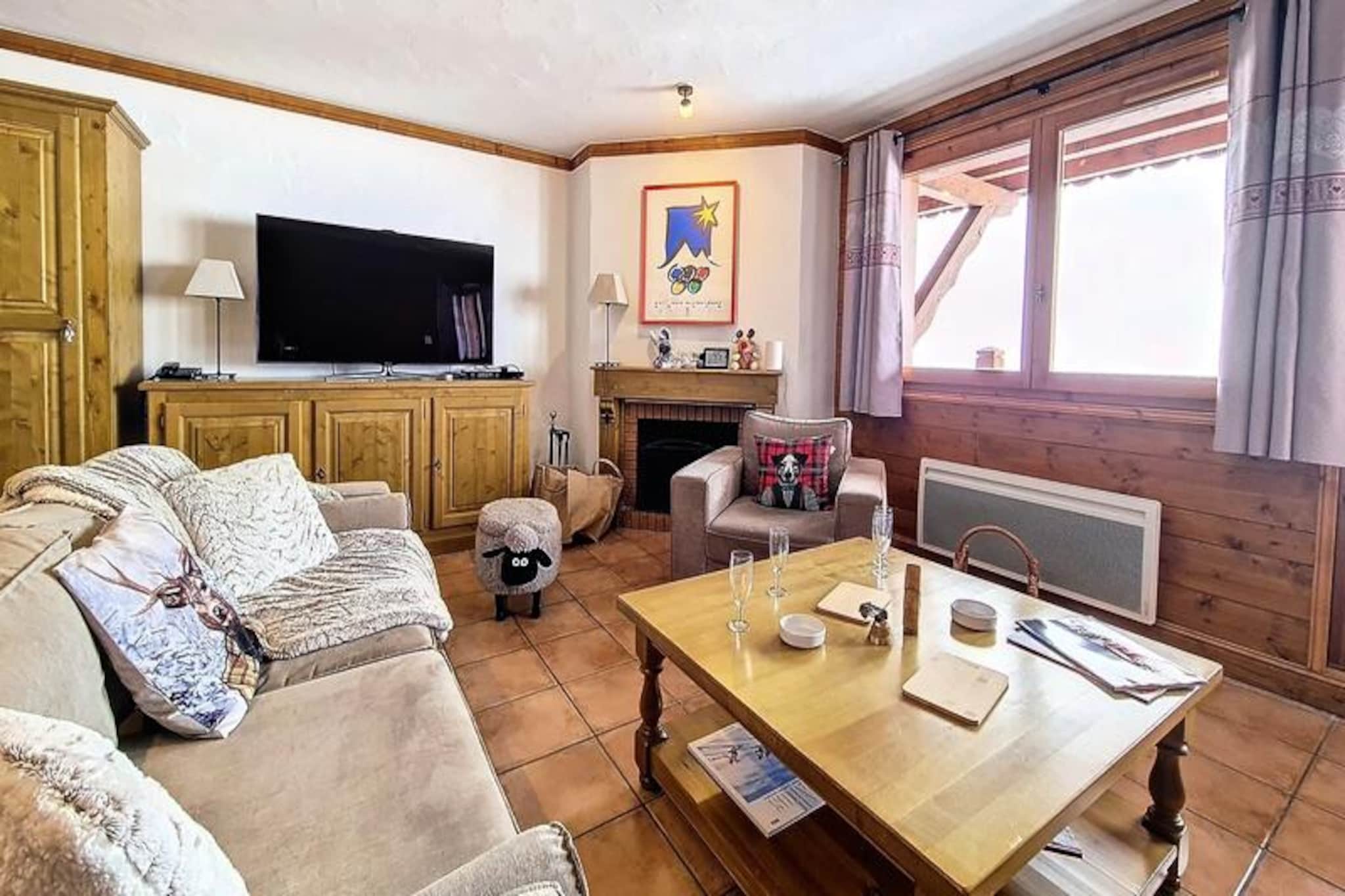 High above the Tarentaise Valley, this elegant 75m² apartment offers a luxurious alpine retreat with breathtaking southwest-facing mountain views. Imagine mornings spent sipping coffee on the balcony as the sun illuminates the peaks, and evenings by the fireplace, sharing stories of the day’s adventures. With ski lifts just steps away, your journey into the pristine Paradiski domain begins effortlessly from the comfort of your doorstep. Whether you’re here for powder-filled slopes or tranquil summer trails, this residence promises an unforgettable escape. \n\nInside, the apartment is thoughtfully designed to combine modern comfort with alpine charm. The bright and spacious living room features a cozy fireplace and a large-screen 4K TV for relaxing after an active day. The open-plan kitchen is fully equipped with high-end appliances, including a fan oven, induction hob, and Nespresso coffee machine, ensuring every meal is a delight. Three well-appointed bedrooms provide restful retreats: two en suite rooms, one with a double bed and private bath, and another with twin beds and a shower. A third bedroom with twin beds, a separate bathroom with a bathtub, and an additional toilet complete the layout, making it ideal for families or groups of friends. \n\nConveniently located, the apartment offers easy access to local amenities, including ski schools, rental shops, and après-ski venues. In summer, the region transforms into a haven for hikers, mountain bikers, and nature enthusiasts, with the majestic Aiguille Rouge and Vanoise National Park nearby. Whether you’re exploring the vibrant Bourg-Saint-Maurice or soaring above the valley in a paraglider, every moment is steeped in alpine magic. \n\nThis is more than just a place to stay—it’s a gateway to the wonders of the French Alps, where comfort meets adventure in perfect harmony.