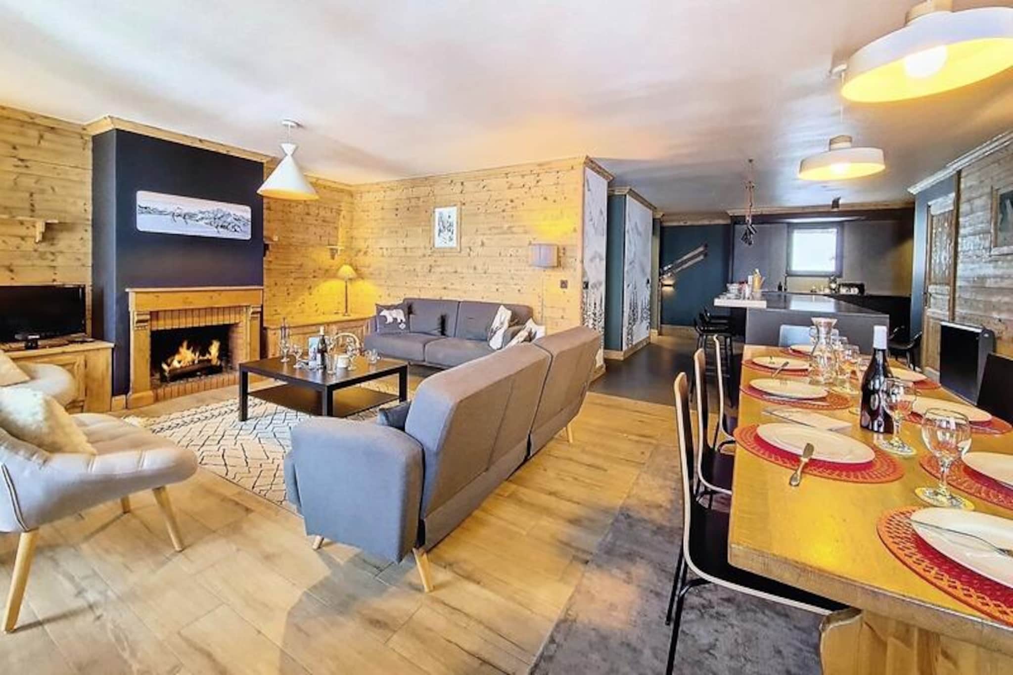 High above the serene slopes of the French Alps, this expansive 140m² triplex apartment offers a luxurious retreat for winter and summer adventurers alike. Imagine waking up to breathtaking views of the ski area from your south-facing balcony, where the crisp alpine air invigorates your senses and the sun bathes the landscape in golden light. Here, every moment feels like an escape into nature’s grandeur, yet with all the comforts of modern living at your fingertips. \n\nStep inside to discover a thoughtfully designed space that blends warmth and sophistication. The open-plan kitchen, equipped with premium appliances including an induction hob, conventional oven, and large refrigerator, invites you to gather around the central island for hearty breakfasts or evening meals. The bright living room, anchored by a stunning fireplace, opens onto a sunny terrace, creating the perfect setting for relaxation after a day on the slopes. With five en-suite bedrooms, including two with private balconies, this apartment comfortably accommodates families or groups of up to twelve guests, ensuring privacy and comfort for all. \n\nLocated directly on the slopes, this property offers unparalleled ski-in/ski-out access, making it a dream for winter sports enthusiasts. In summer, the surrounding trails beckon hikers and cyclists to explore the pristine beauty of the Tarentaise Valley. Nearby, charming alpine villages and local markets provide a taste of authentic Savoyard culture, while the majestic peaks of the Vanoise National Park promise unforgettable adventures. \n\nWhether you’re seeking thrilling descents, tranquil hikes, or simply a place to unwind in style, this apartment is your gateway to the best of the Alps. Let the magic of the mountains create memories that will last a lifetime.