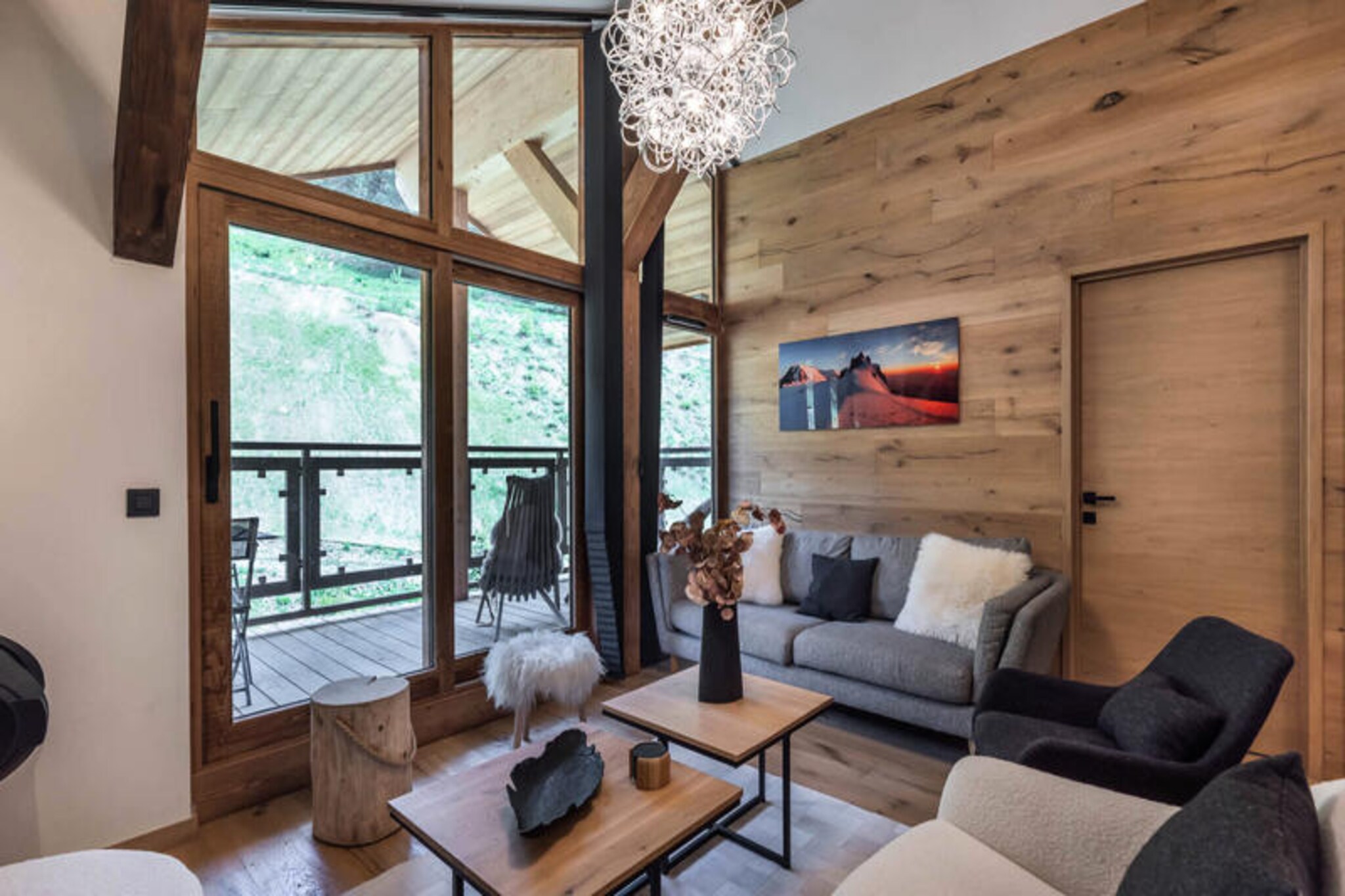 High above the picturesque slopes of Courchevel Moriond, this elegant apartment in the Domaine de l'Ariondaz offers a luxurious alpine retreat for families and friends. Located on the top floor of the Résidence Fritillaire, it combines modern comfort with breathtaking views and convenient access to the ski slopes, just 340 meters away. Whether you're here to carve through pristine snow or bask in the mountain sun, this property promises an unforgettable stay in the heart of the French Alps. \n\nThe apartment spans approximately 80 square meters and is thoughtfully designed to accommodate up to four adults and three children. It features two spacious double bedrooms, one with an en-suite shower and heated towel rail, and a cozy cabin bedroom with bunk beds. The living area is a welcoming space with a wood-burning fireplace, a south-facing balcony, and a stylish dining area. The open-plan kitchen is fully equipped with modern appliances, including a dishwasher, induction hob, microwave, and oven, ensuring you have everything you need to prepare hearty meals after a day on the slopes. Additional amenities include a washer-dryer, ski locker, and private covered parking spaces with boot racks and an electric car charging point. \n\nBeyond the apartment, Courchevel Moriond offers a vibrant atmosphere with shops, restaurants, and après-ski activities all within walking distance. The ski-in/ski-out access makes it effortless to explore the renowned Three Valleys ski area, while the surrounding trails and panoramic views provide endless opportunities for adventure and relaxation. \n\nWith its exceptional location, luxurious amenities, and warm alpine charm, this apartment is the perfect base for creating cherished memories in the French Alps.