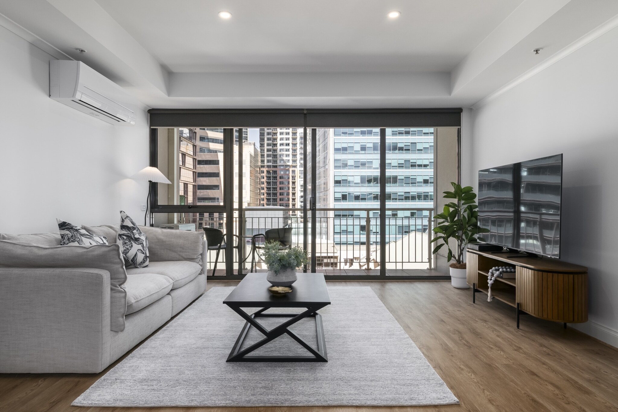 Property description
Set in Melbourne’s vibrant CBD, this 3-bedroom apartment offers a relaxing retreat with spacious interiors and modern comfort. Enjoy open-plan living, access to resort-style facilities including a pool, gym and tennis court. With a private balcony and stylish furnishings, it’s ideal for families, business travellers or a city break.
The space
Step inside this light-filled city apartment where contemporary living meets homely comfort. The open-plan lounge features a large, three-seater couch, a coffee table, hardwood floors, and a flat-screen TV with free-to-air channels. Natural and artificial touches, including indoor plants and modern styling, bring warmth to the space.
The dining area comfortably seats six, with two additional seats at the kitchen bench—perfect for family meals or entertaining. The fully equipped kitchen includes a gas stovetop, electric oven, microwave, dishwasher, and coffee machine compatible with capsules. Ample cookware and utensils ensure everything is on hand for a home-cooked meal.
Each of the three bedrooms is furnished with queen beds, oil heaters, blackout blinds, and ceiling fans for year-round comfort. One bedroom features a private ensuite, while the main bathroom also houses a laundry with a washer, dryer, and laundry essentials.
Step out onto the private balcony accessed via the living room, complete with outdoor furniture—ideal for a morning coffee or evening wind-down. Enjoy access to the building’s gym, pool, and tennis court, all located on the ground floor.