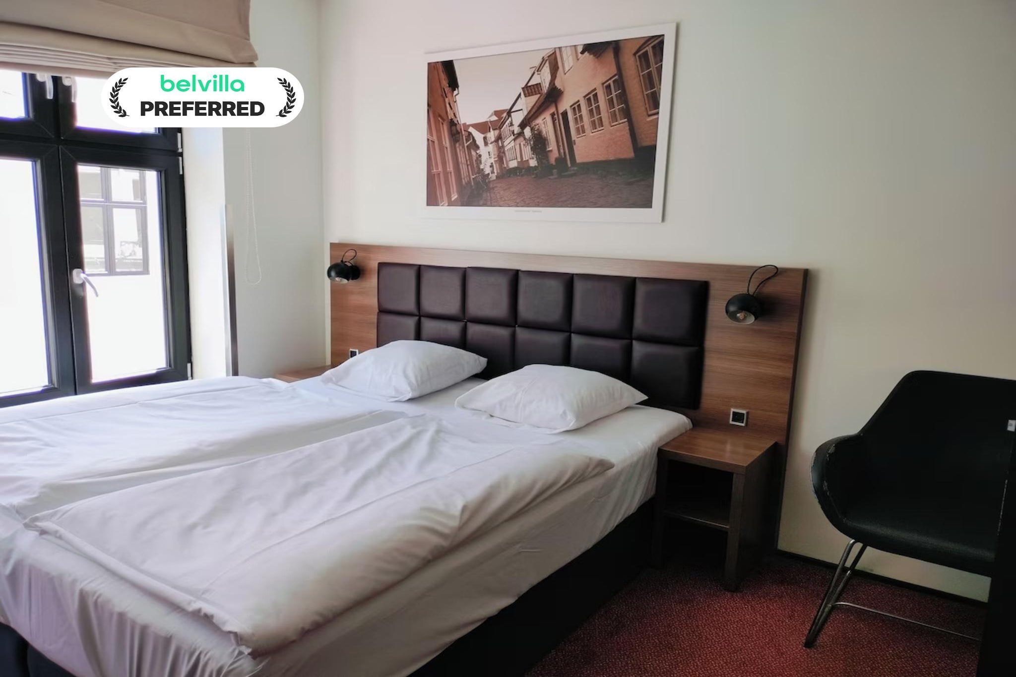 Set directly on the lively Jomfru Ane Gade pedestrian street in central Aalborg, this welcoming hotel gives guests the ideal base to enjoy the city’s culture, nightlife, and charm. Modern comforts such as free Wi-Fi throughout the property and a breakfast buffet make your stay easy and enjoyable. Guests can enjoy snacks and drinks available for purchase on weekends. Restaurant and café discount vouchers offer a great way to experience Aalborg’s local flavours.

Standard Double Room Features -
1. Comfortable double bed perfect for couples or solo travellers
2. Private bathroom with shower, towels, and toiletries
3. Flat-screen TV with cable channels
4. Work desk and wardrobe for added convenience
5. Hairdryer, heating, and free Wi-Fi
6. Soft lighting and bright décor for a cozy atmosphere
7. Non-smoking room with simple, modern Scandinavian style

Hotel Amenities & Guest Perks -
1. Free high-speed Wi-Fi across the hotel
2. Breakfast Service Available in a cheerful dining area
3. Weekend snacks and beverages available
4. Discount vouchers for nearby cafés and restaurants
5. Express check-in/check-out
6. Fire safety system, smoke detectors, CCTV
7. Friendly multilingual staff
8. Paid parking for 130DKK/night

Nearby Attractions -
1. Aalborghus Castle – approx. 250 m
2. Aalborg Historical Museum – approx. 600 m
3. Limfjord waterfront – short walk
4. Aalborg Train Station – approx. 13 minutes on foot
5. Restaurants, shops, and entertainment venues all around

How to Reach -
1. Aalborg Train Station is within walking distance
2. Good local bus connections
3. Aalborg Airport – approx. 15 minutes by car

Enjoy a comfortable stay in the heart of Aalborg with everything you need just steps away.