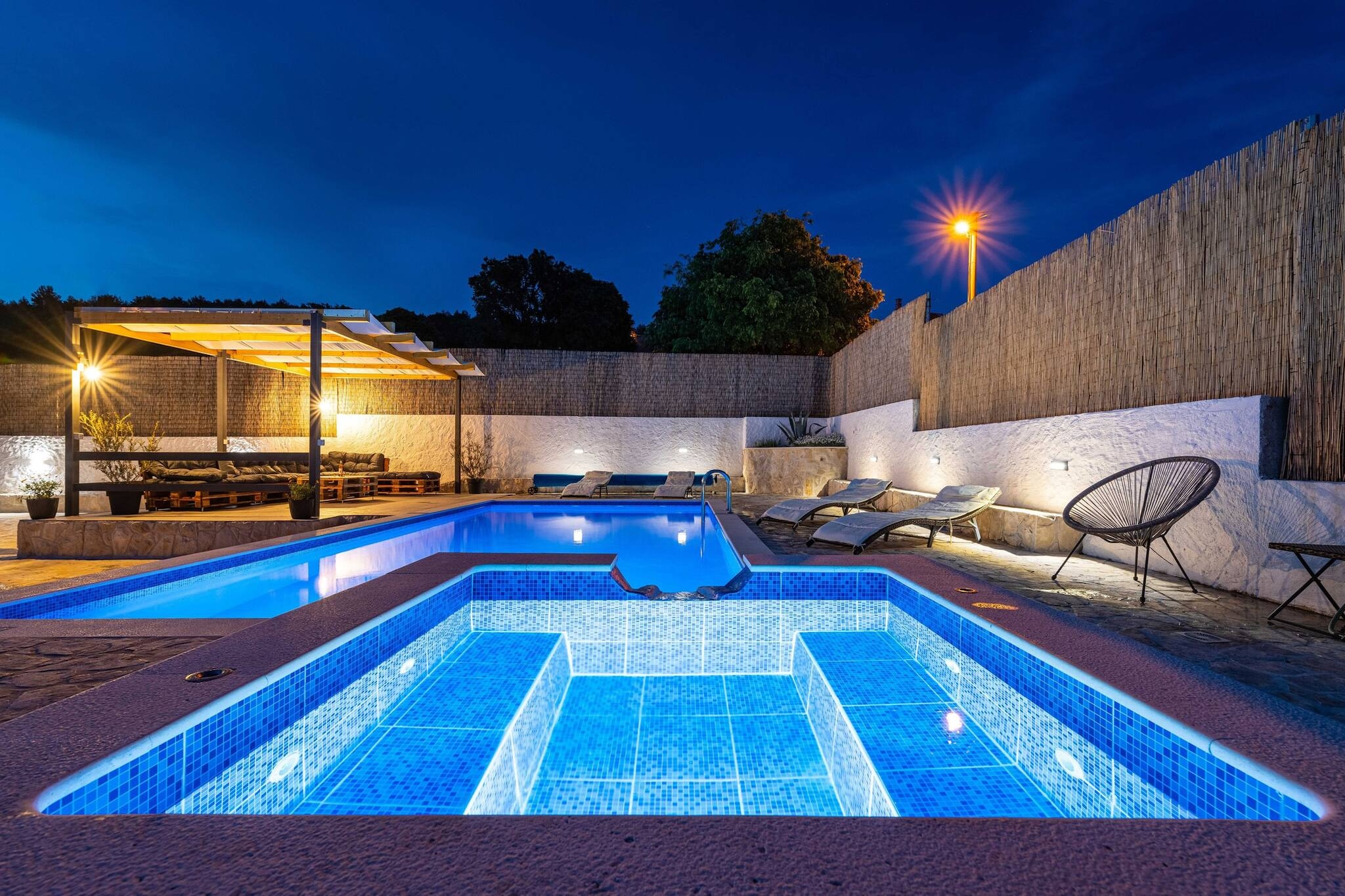 Ground floor: (Living room(double sofa bed, TV(satellite), dining table, fireplace, seating area), open kitchen(hob(induction), electric kettle, toaster, coffee machine, oven, microwave, dishwasher, fridge-freezer, dishes and cutlery, Cooking basics, Wine glasses), bathroom(shower, washbasin, toilet))\n\nOn the 1st floor: (bedroom(single bed, single bed), bedroom(double king size bed, TV(satellite)), bedroom(double bed), bathroom(shower, washbasin, toilet, hairdryer))\n\nInternet access, Garden Furniture , hot tub, bidet, washing machine, balcony, air conditioning, terrace, garden(fenced), sun loungers, BBQ, parking, swimming pool(private, outside, heated), ironing board, outdoor fireplace, baby crib(free), hot water, Essentials, Cleaning products