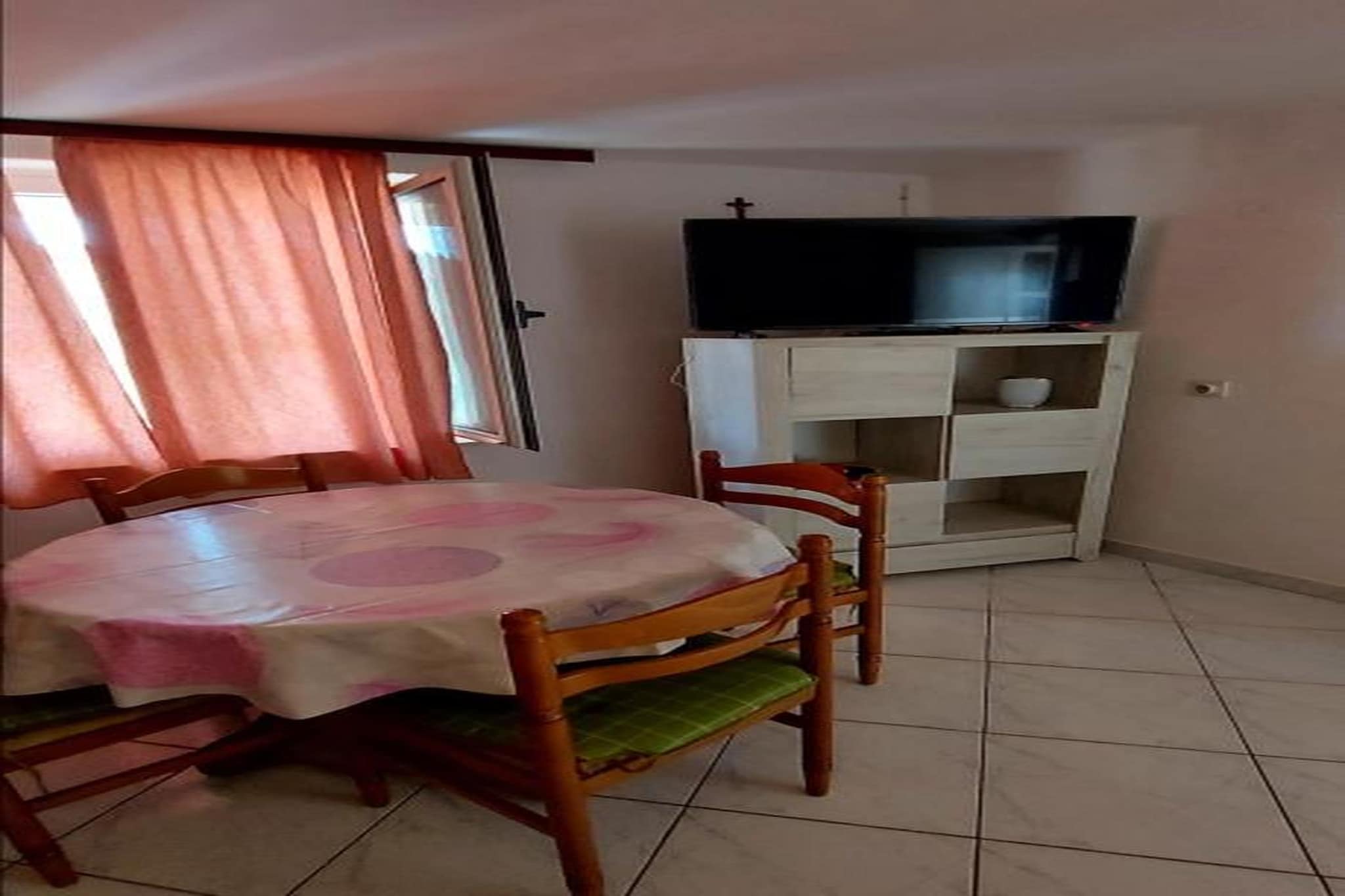 Welcome to this inviting ground-floor apartment in Okrug Gornji, perfect for families or small groups of up to four guests. Designed for comfort and relaxed island living, the apartment features a cosy living room with a comfortable seating area, TV and a charming fireplace—ideal for unwinding after a day at the beach. The adjoining dining area and open kitchen come fully equipped with a coffee machine, electric kettle, fridge-freezer, dishes, cutlery and cooking basics, making mealtimes easy and enjoyable.

The apartment offers two bedrooms, each furnished with either a double bed or two single beds, allowing flexibility for couples, friends or families. The modern bathroom is fitted with a shower, washbasin and toilet. With internet access, a private terrace for outdoor relaxation and a grill for sunny al fresco meals, the home provides everything you need for a pleasant and carefree stay. Guests also have access to a shared swimming pool—perfect for cooling off under the warm Dalmatian sun. Private parking is available for added convenience.

Nestled on the island of Čiovo, Okrug Gornji offers a perfect blend of calm surroundings and lively coastal charm. Beautiful pebble beaches with crystal-clear waters are just minutes away, along with beach bars, cafés and waterfront restaurants serving fresh Mediterranean dishes. A short drive brings you to the UNESCO-listed town of Trogir, known for its enchanting old town, medieval architecture and vibrant harbor. For adventure lovers, boat trips, snorkelling spots and scenic coastal walks are right at your doorstep.