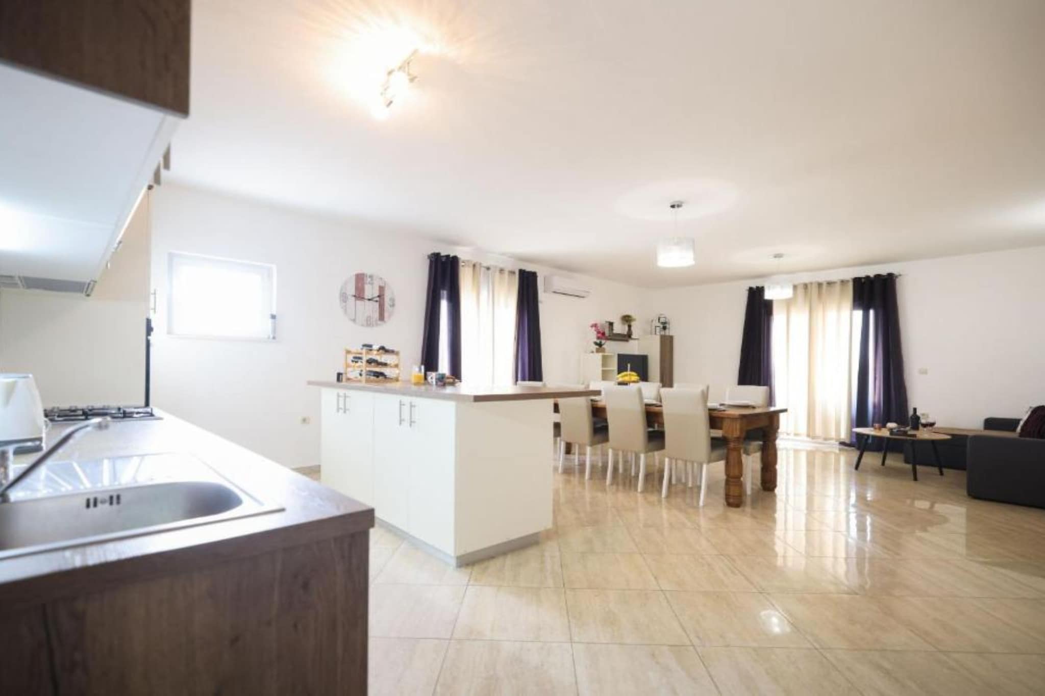 Villa Maja in Škabrnja, Zadar County, Croatia, is a modern holiday villa perfect for families or small groups seeking comfort and tranquility. The villa features a fully equipped kitchen and a sun-filled dining area, and is about 150 meters from the sea and local amenities, with easy access to both Zadar and nearby national parks. The Villa has an additional kitchen in the outside area where the BBQ is.
Note:
Private parking is available, and a reservation is not required.
A baby cot is available on request.
Wi-Fi is available throughout the property.
Pets are not allowed.
This three-bedroom can accommodate up to eight guests. It features a satellite TV and is combined with a living room seating area, a sofa, and a kitchen. The private bathroom is equipped with a shower and toilet.
Thanks to its excellent location, everything you'll need for your vacation is just a short walk from the property. Grocery stores, cafes, restaurants—everything is within a 3.00 km radius.
The airport is 3 km away from the property.